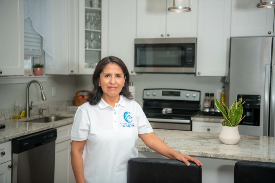a woman standing in the kitchen with a white shirt
