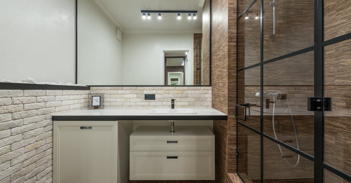 A bathroom with two shower stalls with frosted glass doors