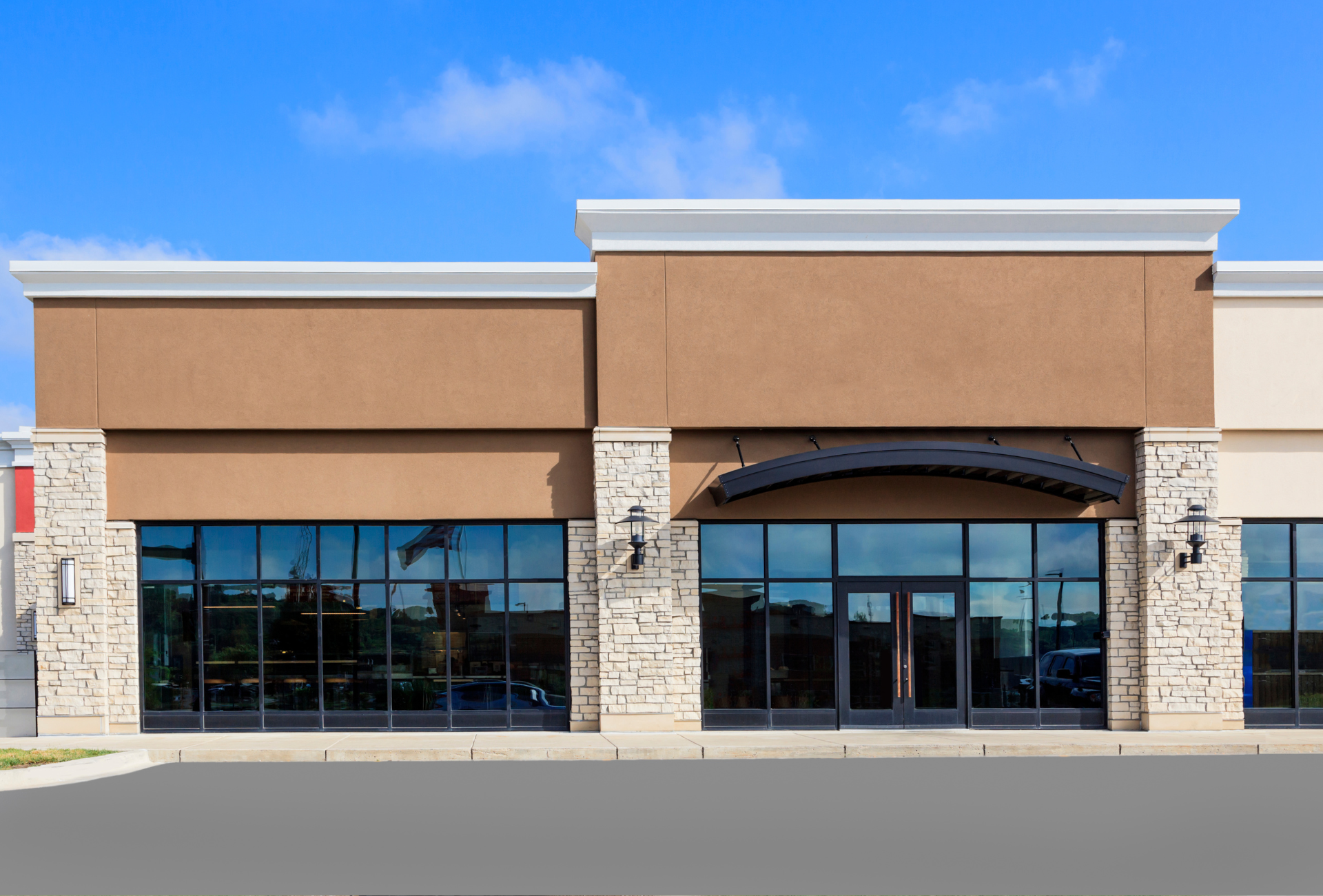A large building with a lot of windows and a blue sky in the background.