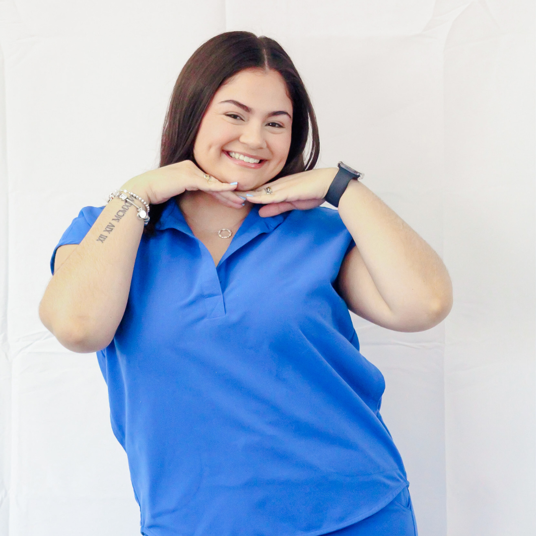 A woman with a tattoo on her arm is wearing a blue shirt