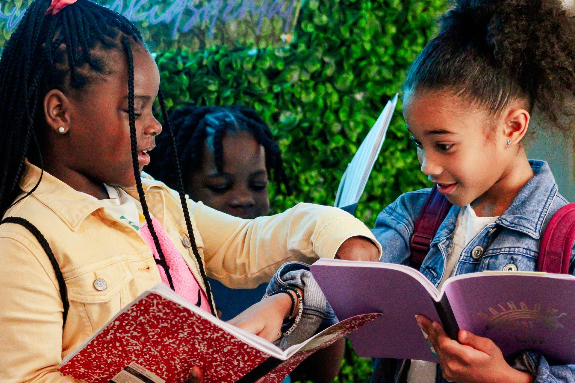 A group of young girls are reading books together.