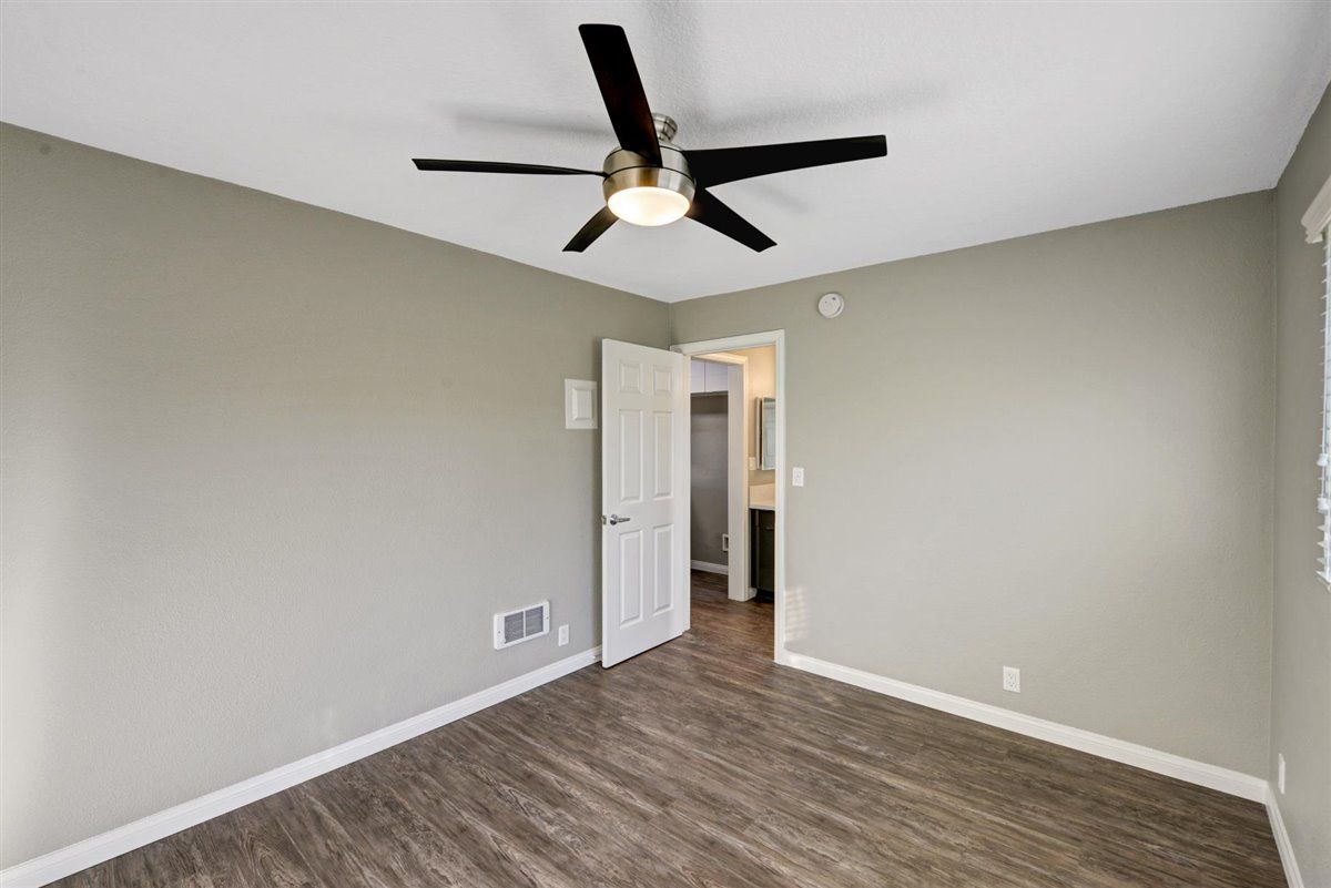 Fair Oaks bed room with fan and door open