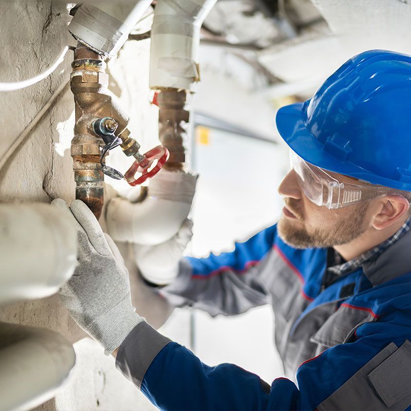 Male Worker Inspecting Valve