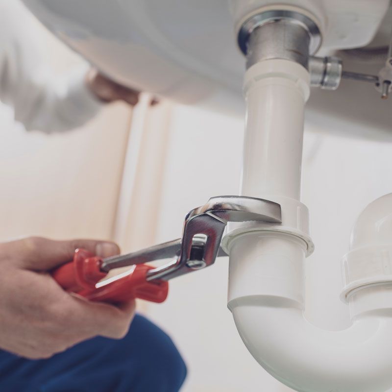 Plumber fixing a sink at home