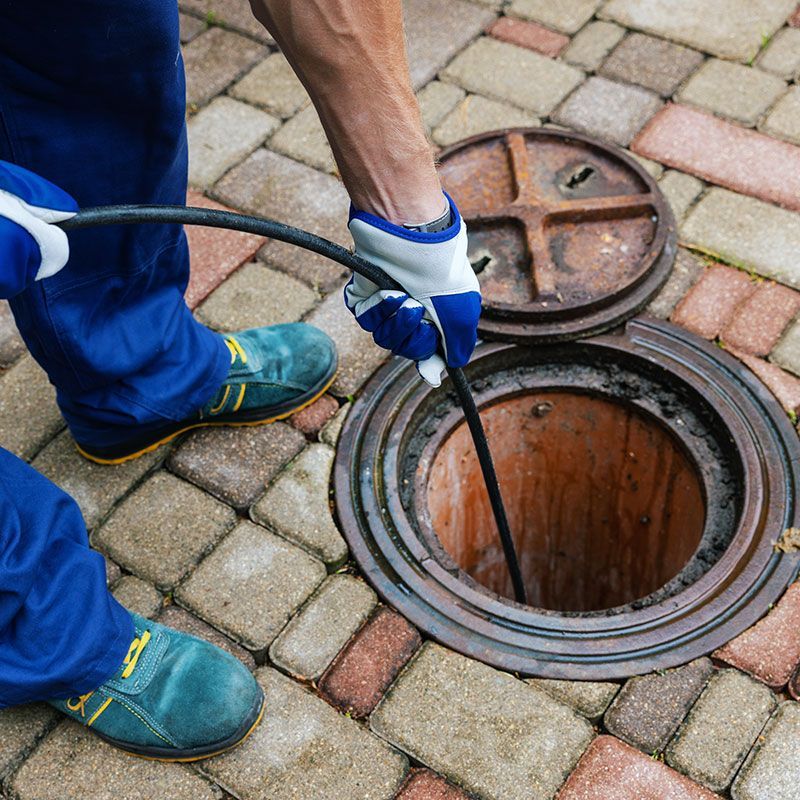 sewer cleaning service - worker clean a clogged drainage with hydro jetting