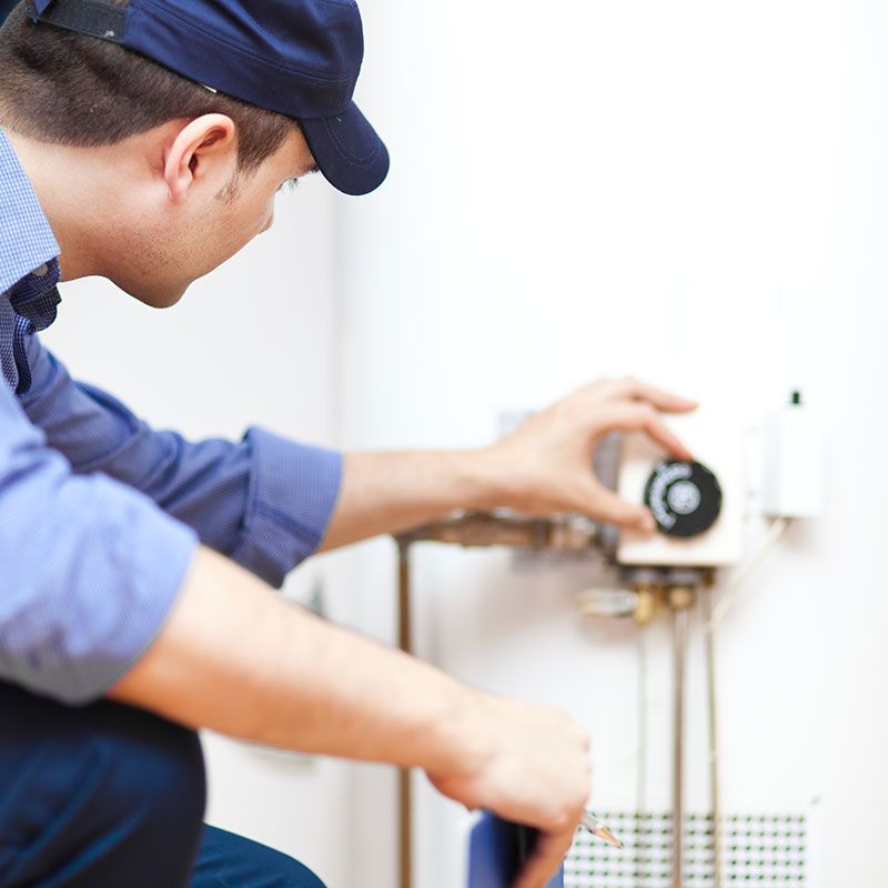 Plumber repairing an hot-water heater