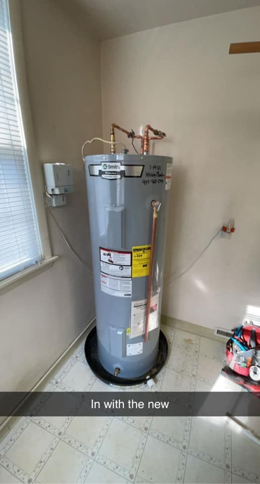 A water heater is sitting in a room next to a window.