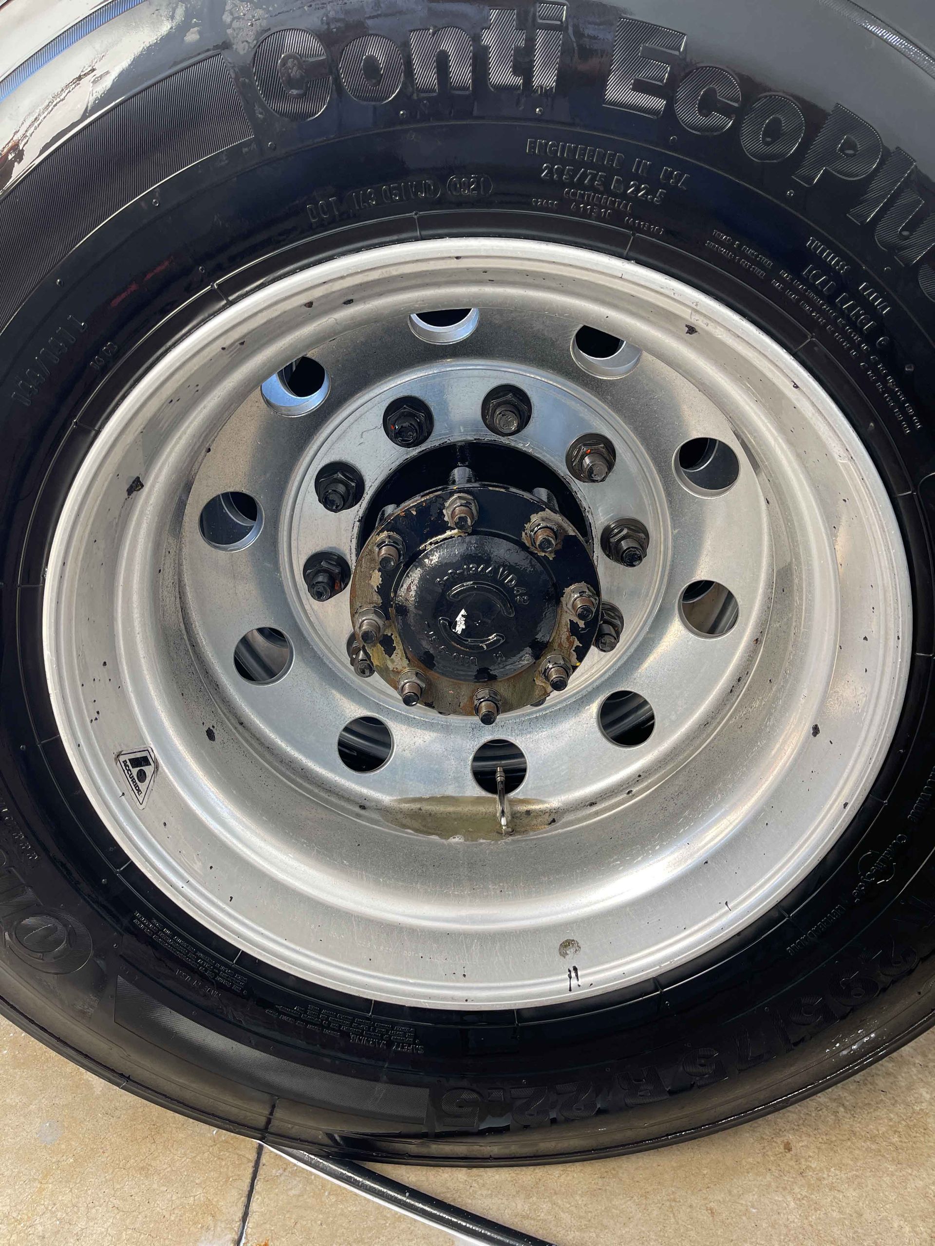 A yellow sports car is parked in a garage.