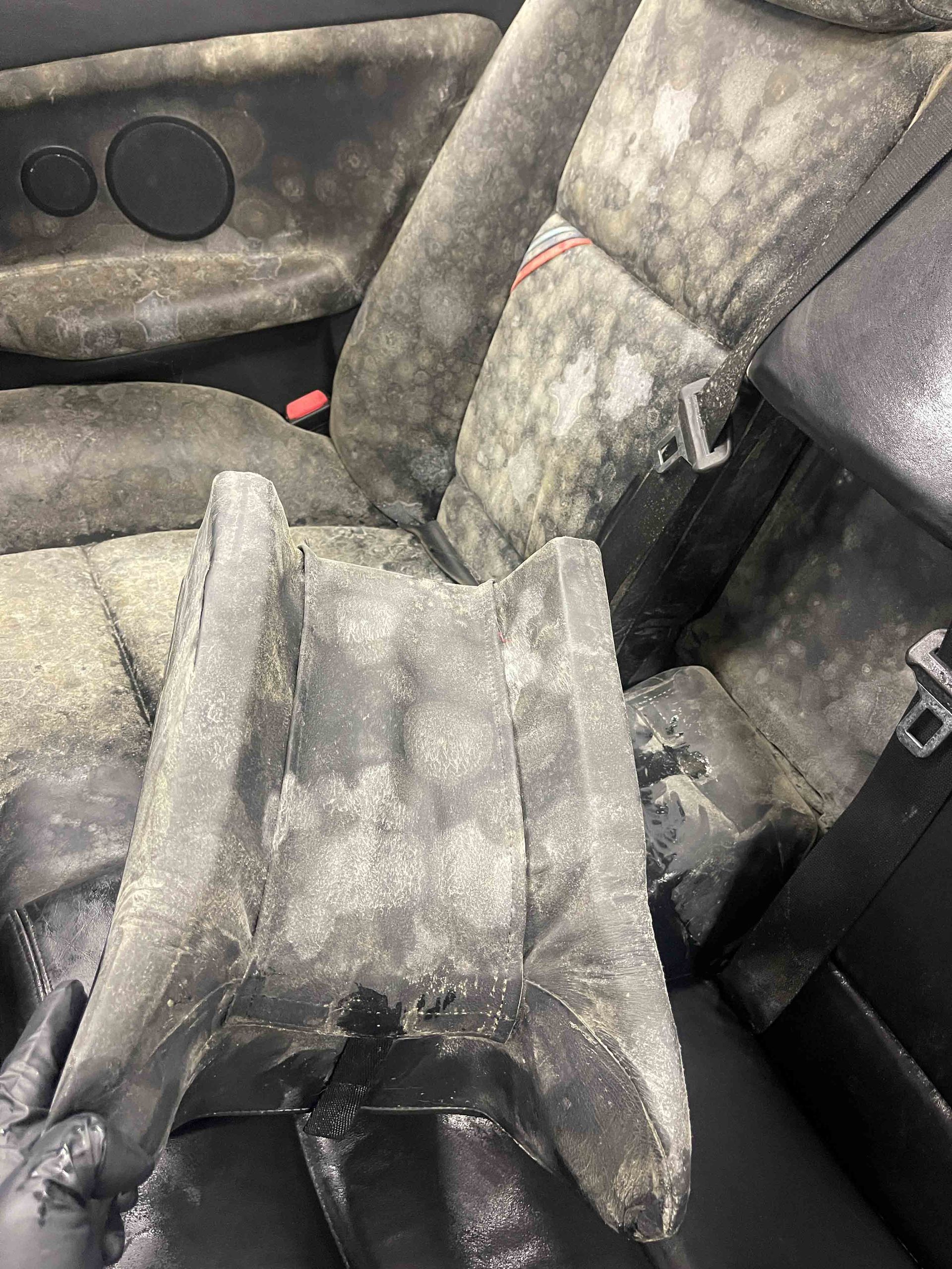 A yellow sports car is parked in a garage.