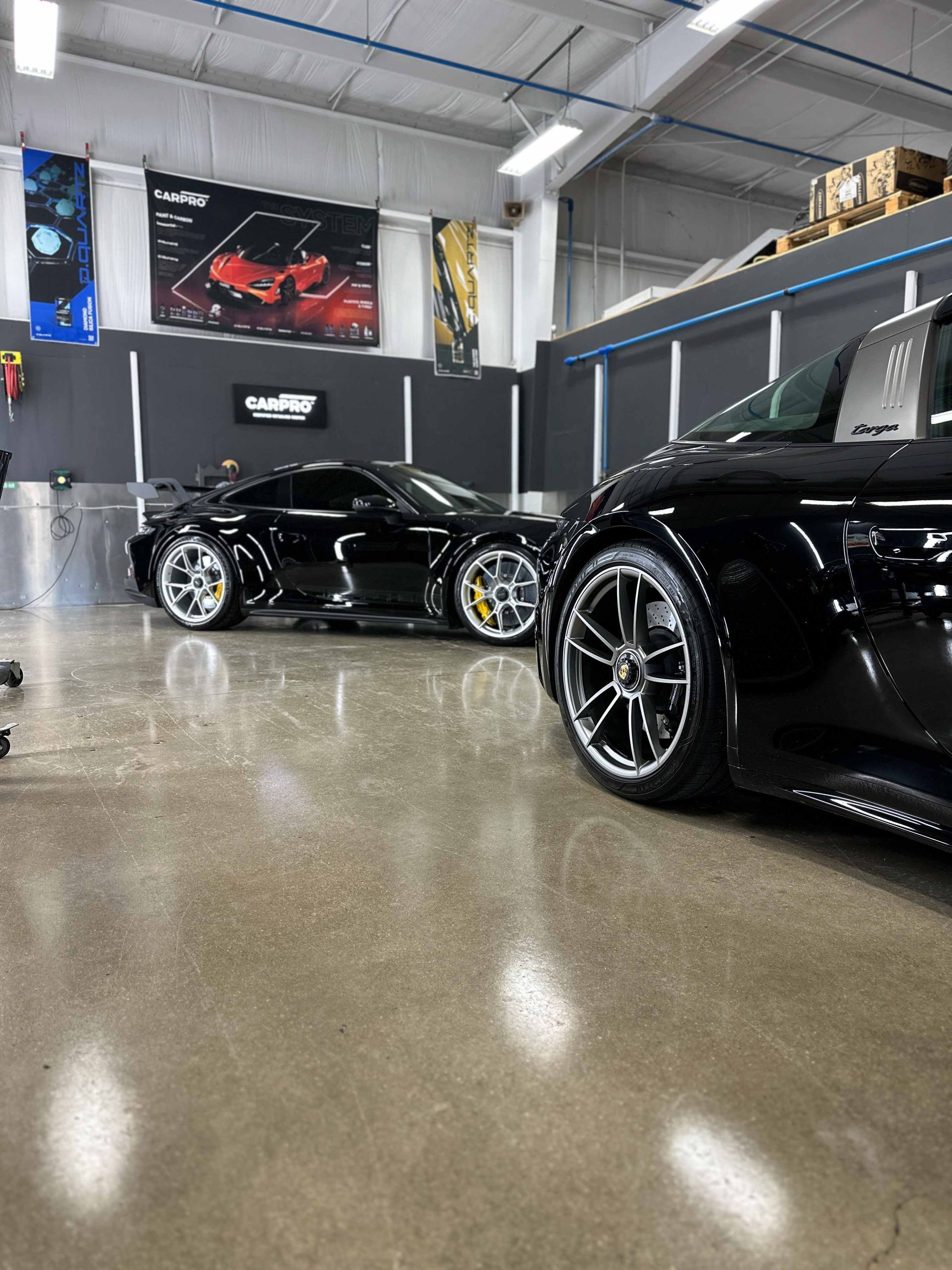A yellow sports car is parked in a garage.
