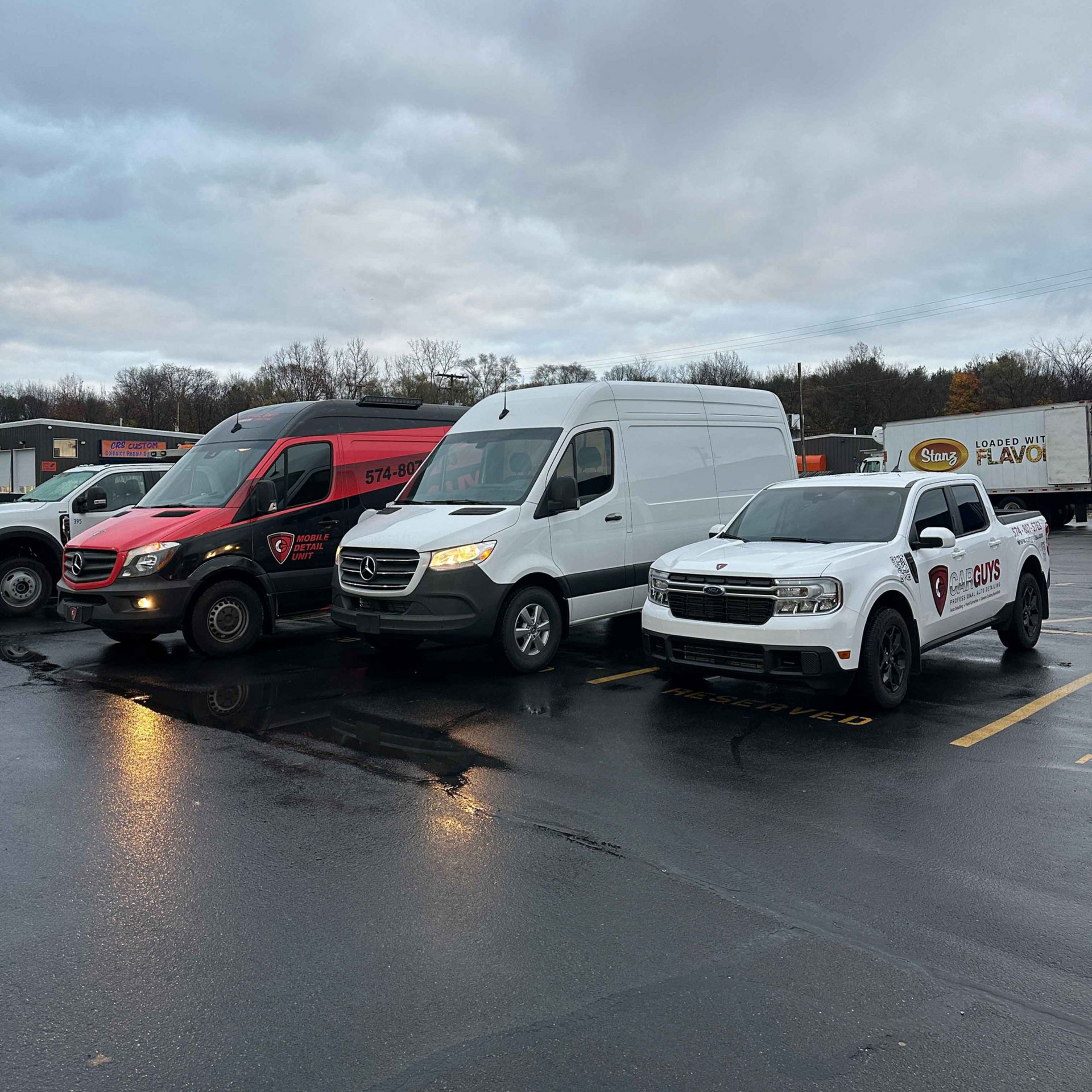 A close up of water drops on the hood of a car