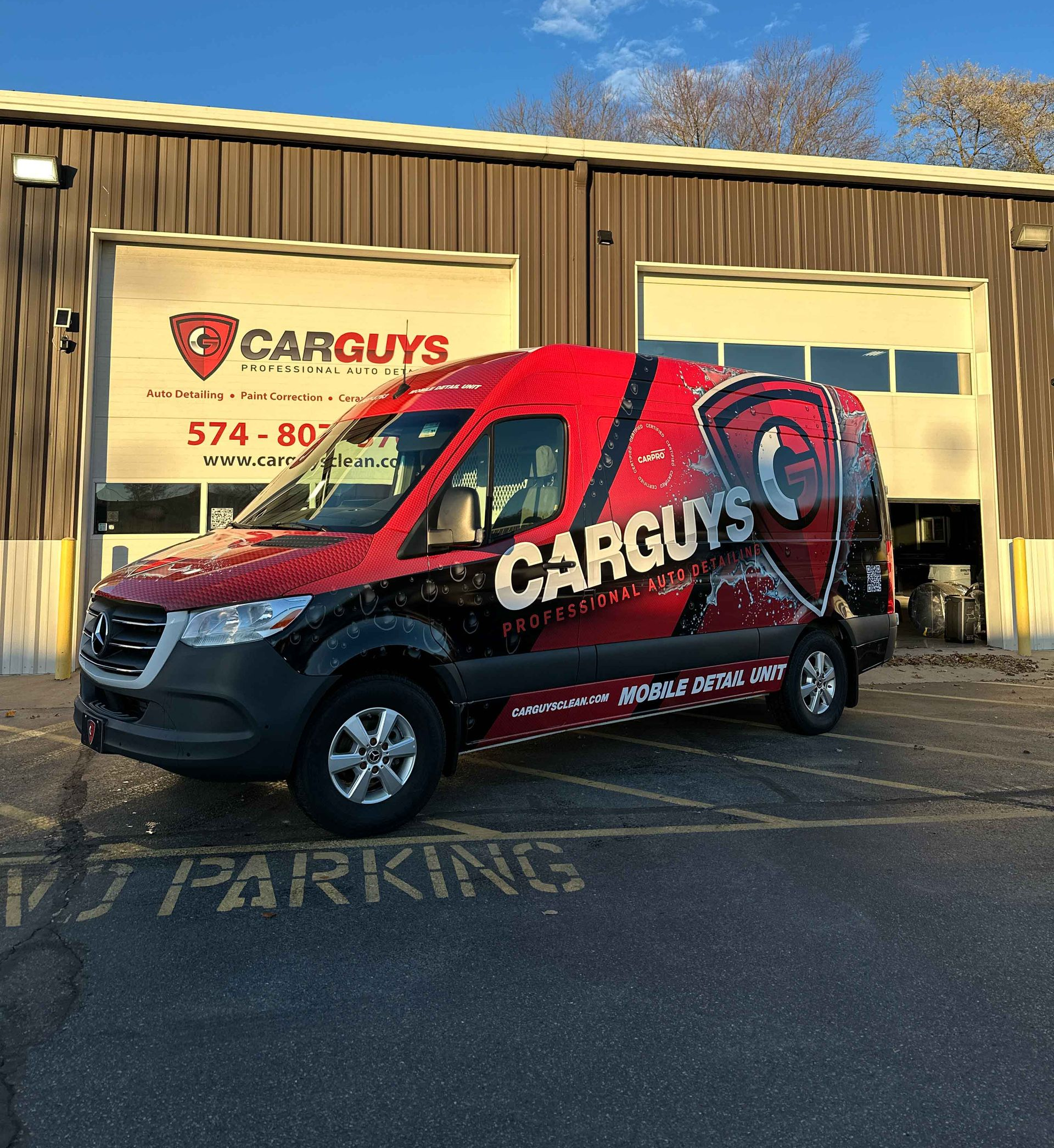 A person is cleaning the interior of a car with a vacuum cleaner.
