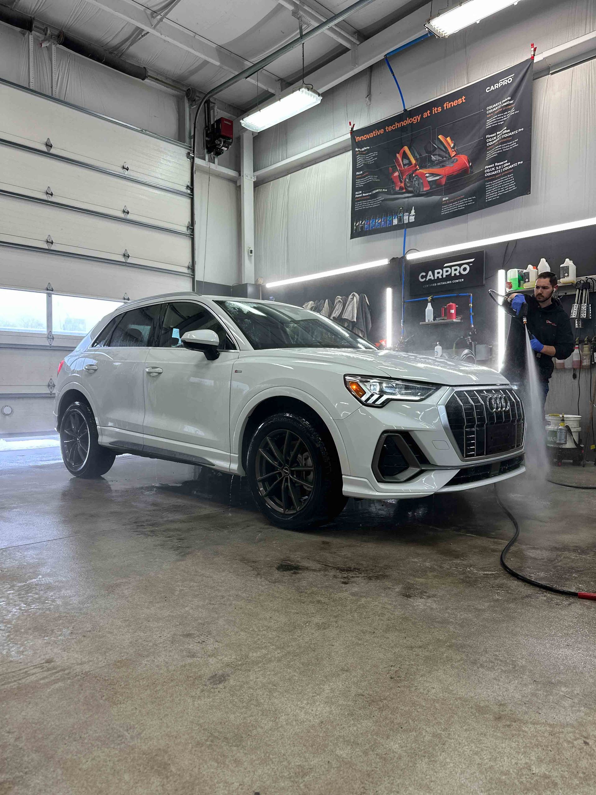 A yellow sports car is parked in a garage.