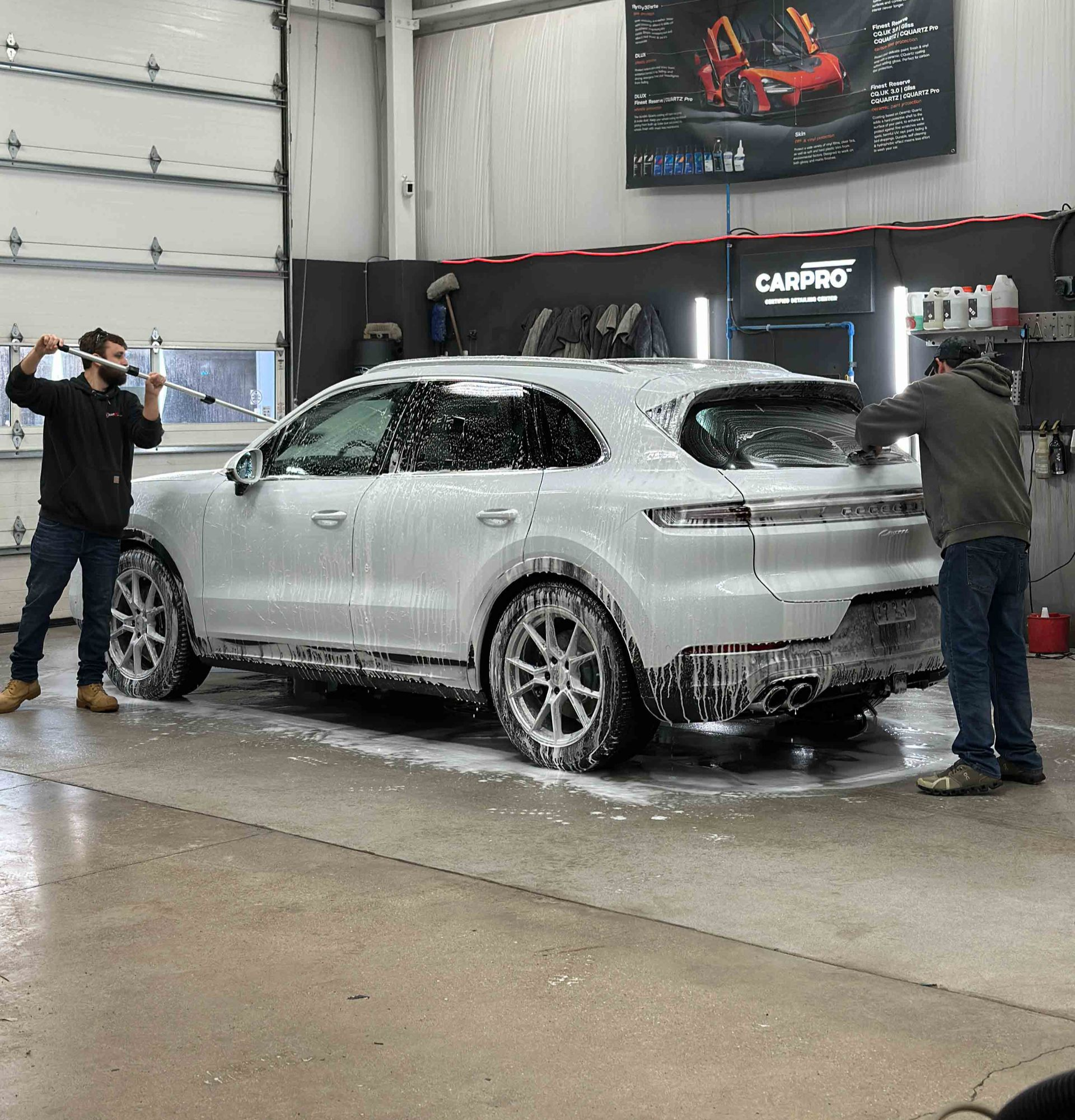 A close up of water drops on the hood of a car