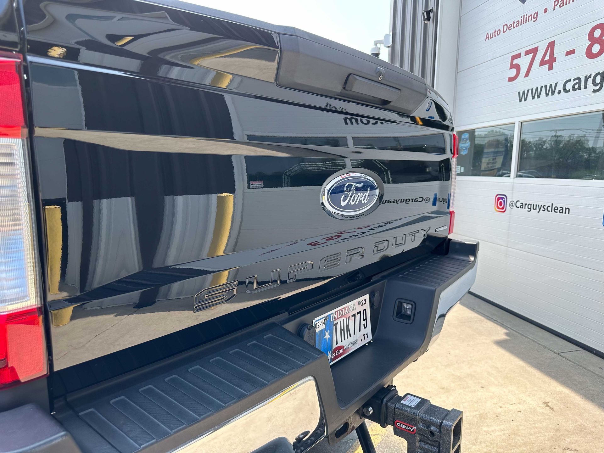 Black Ford pickup truck rear with Ford logo and license plate.