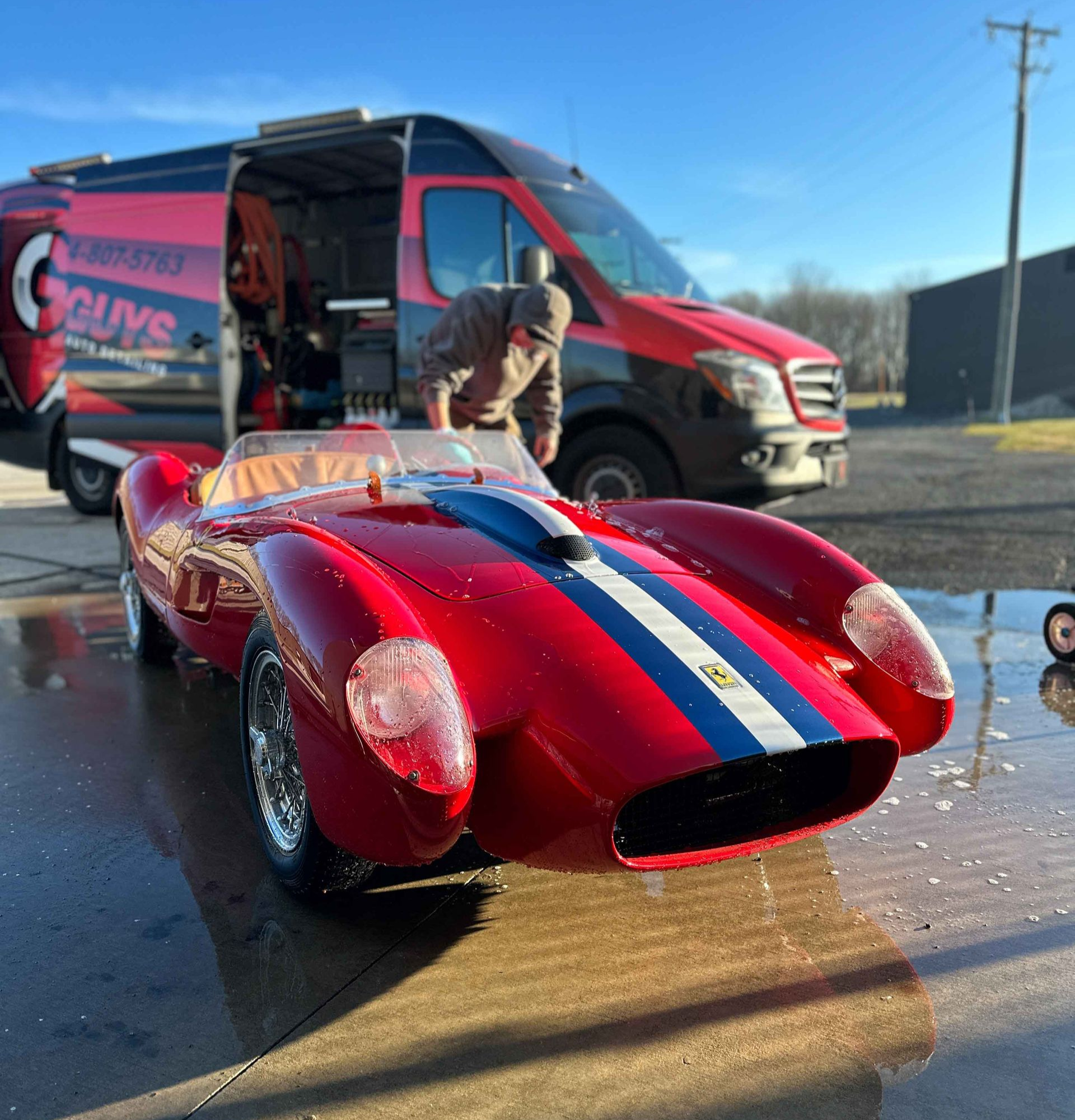 A close up of water drops on the hood of a car