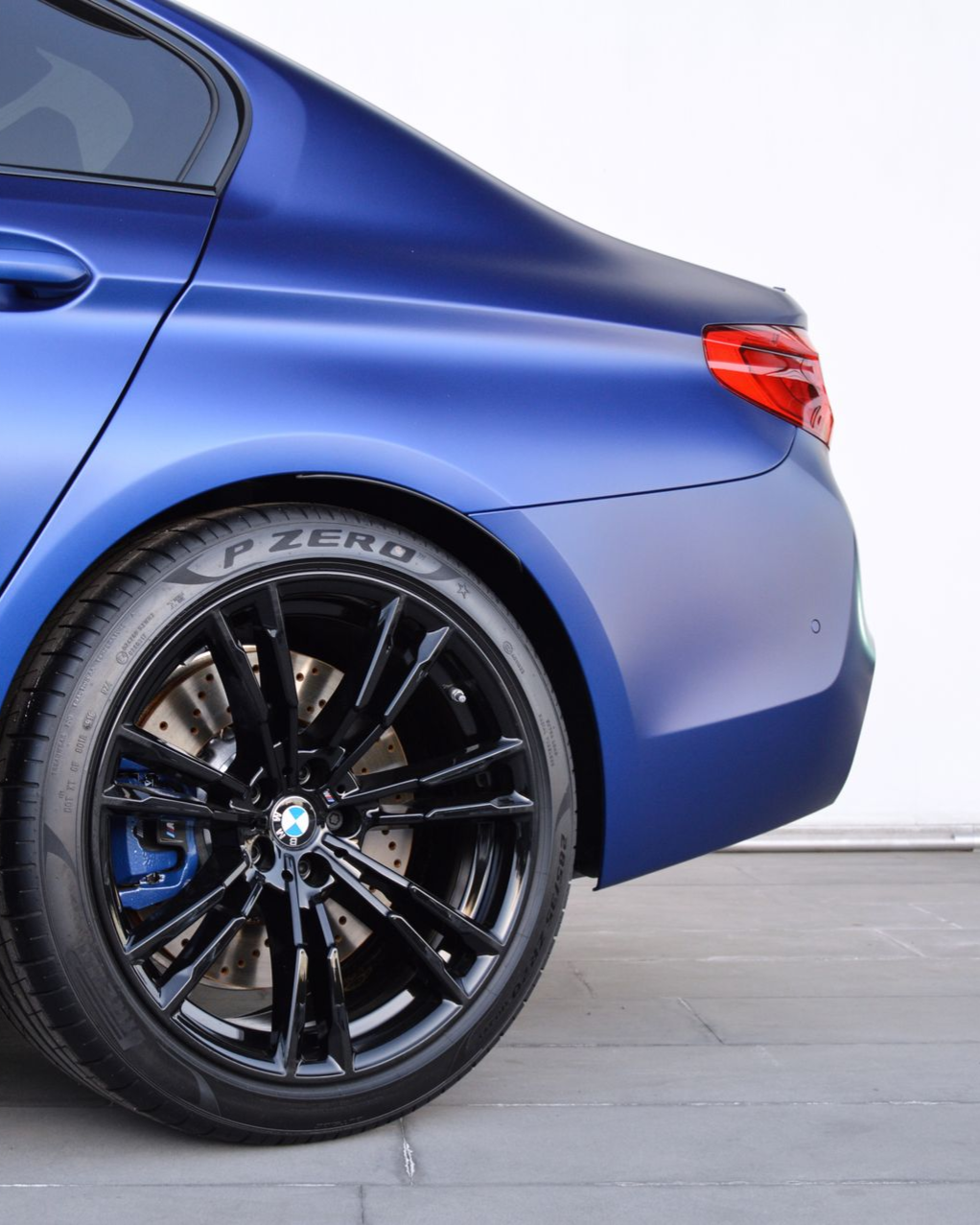 A close up of water drops on the hood of a car