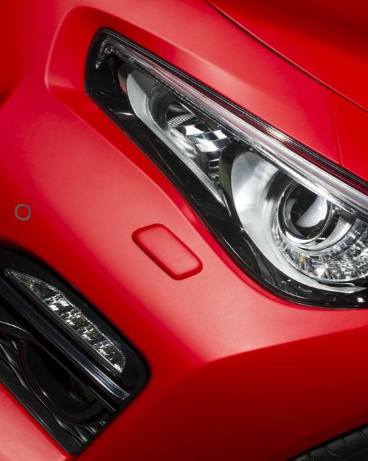 A person is cleaning the interior of a car with a vacuum cleaner.