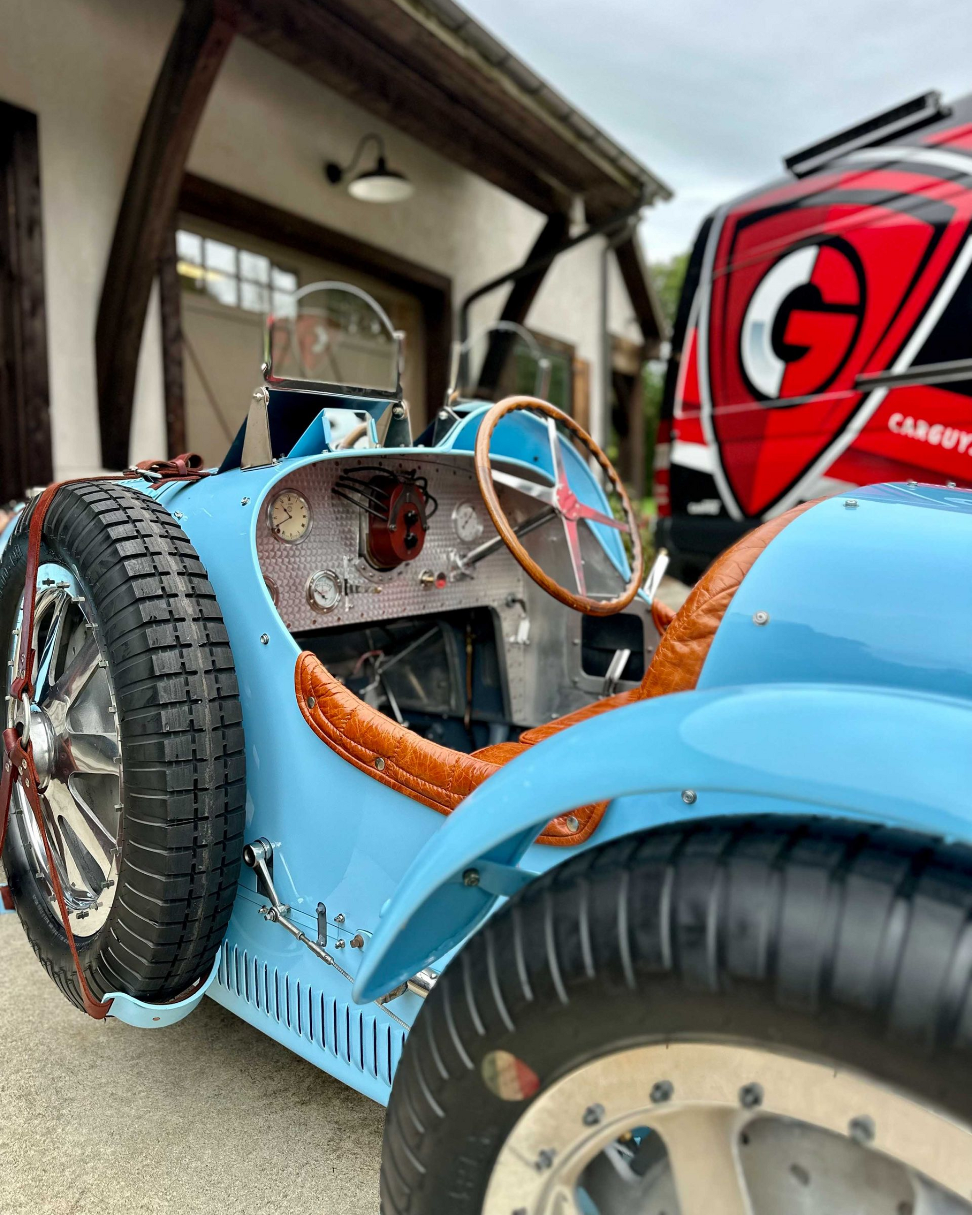 A person is cleaning the interior of a car with a vacuum cleaner.