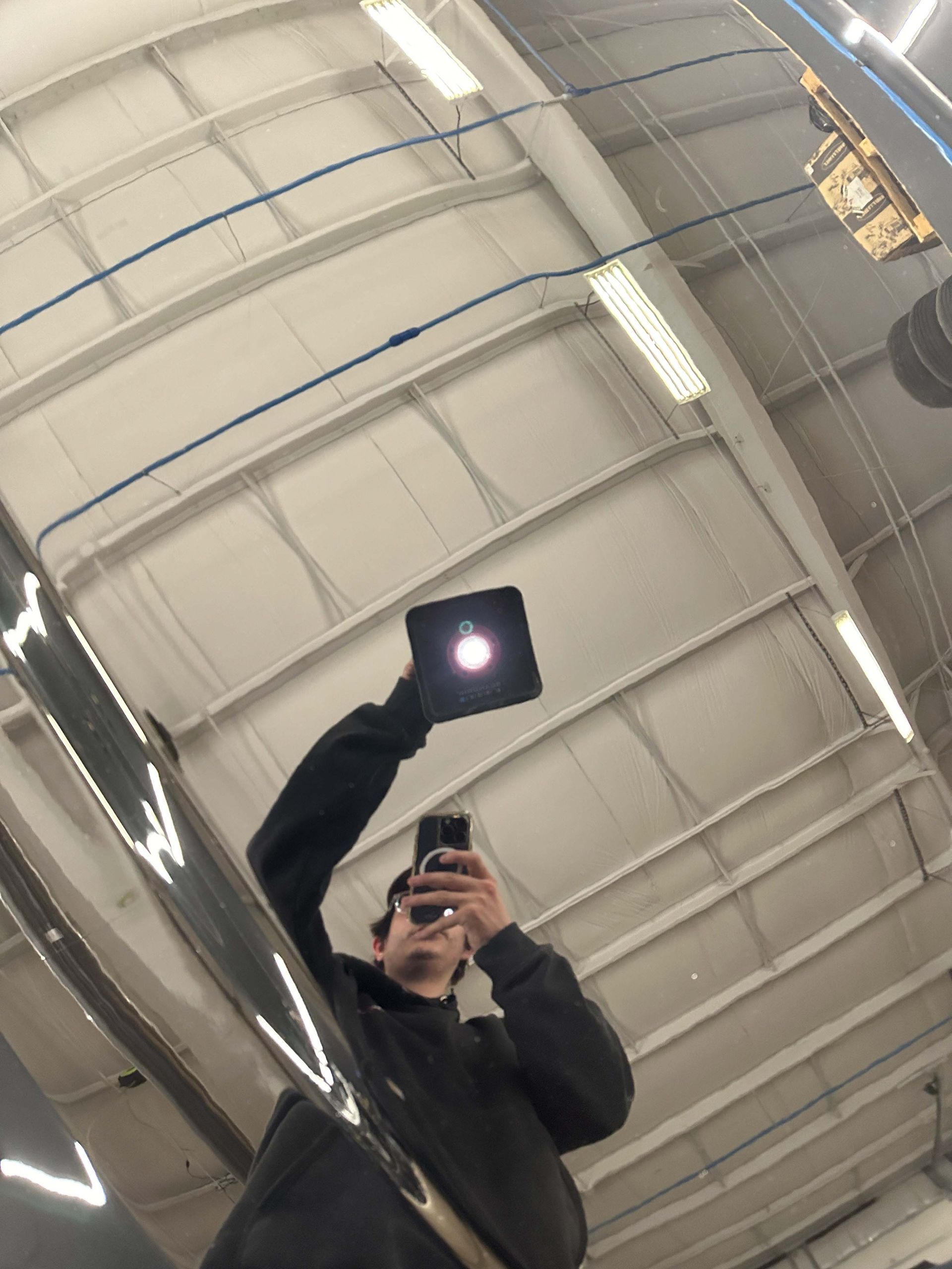 A person is applying tinted glass to a car windshield.