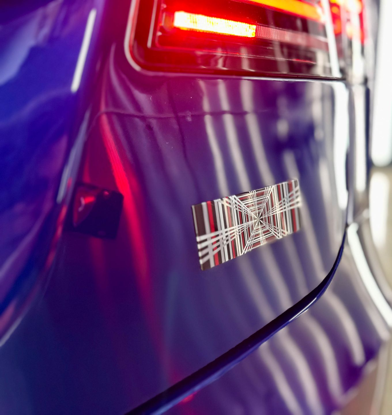 A close up of water drops on the hood of a car