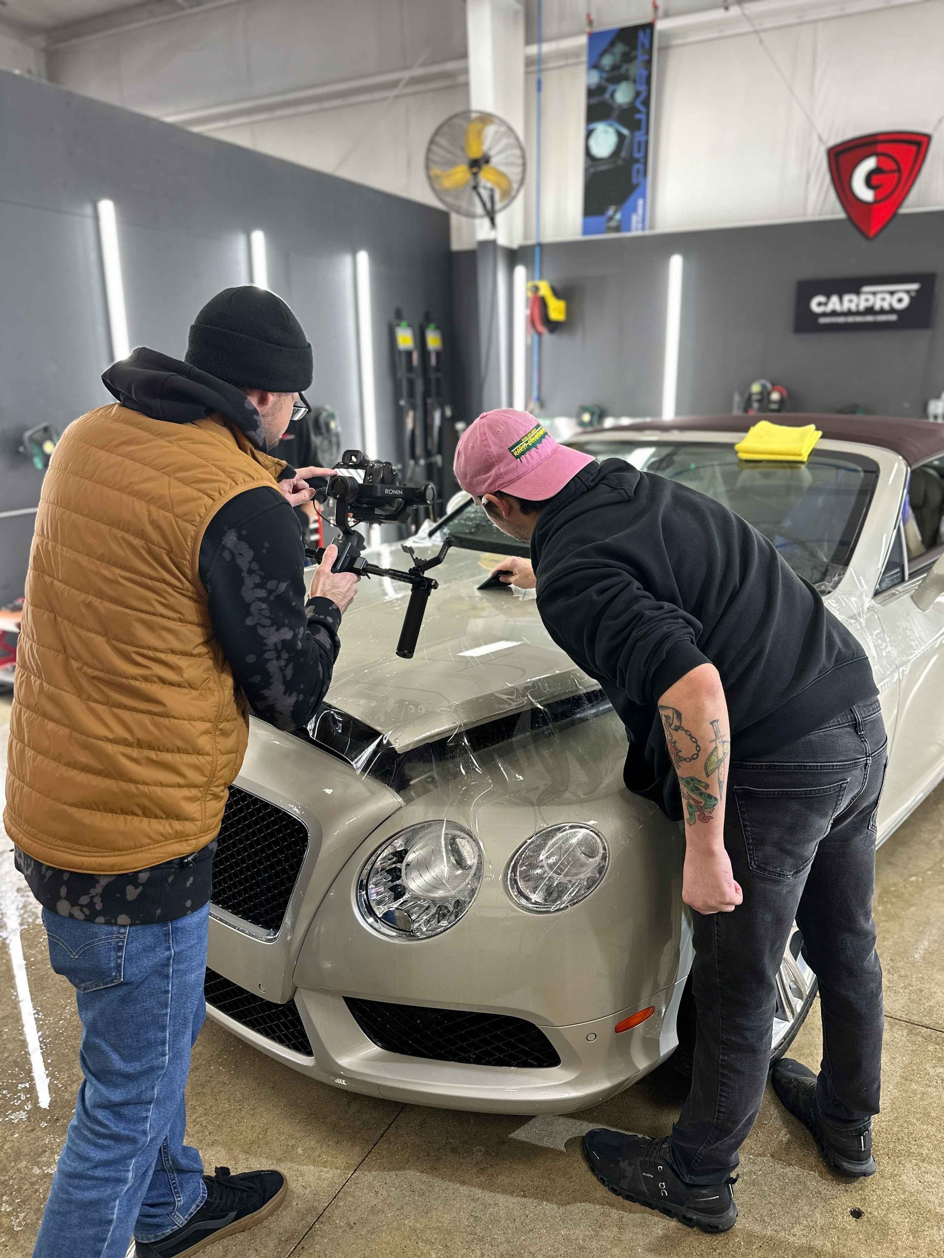 A yellow sports car is parked in a garage.