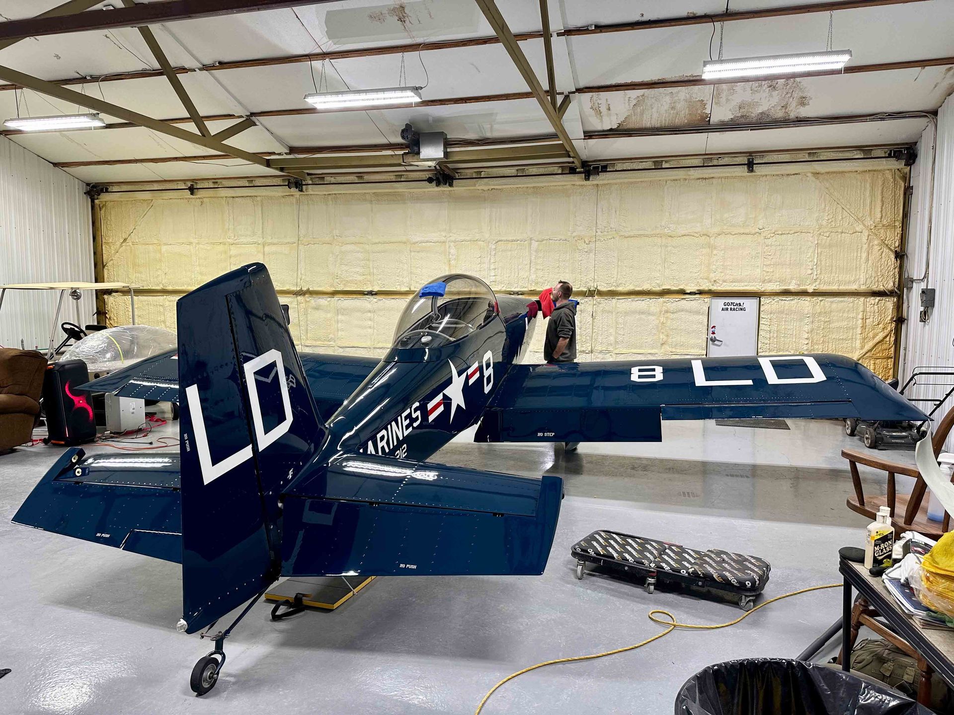 Blue airplane in a hangar; 