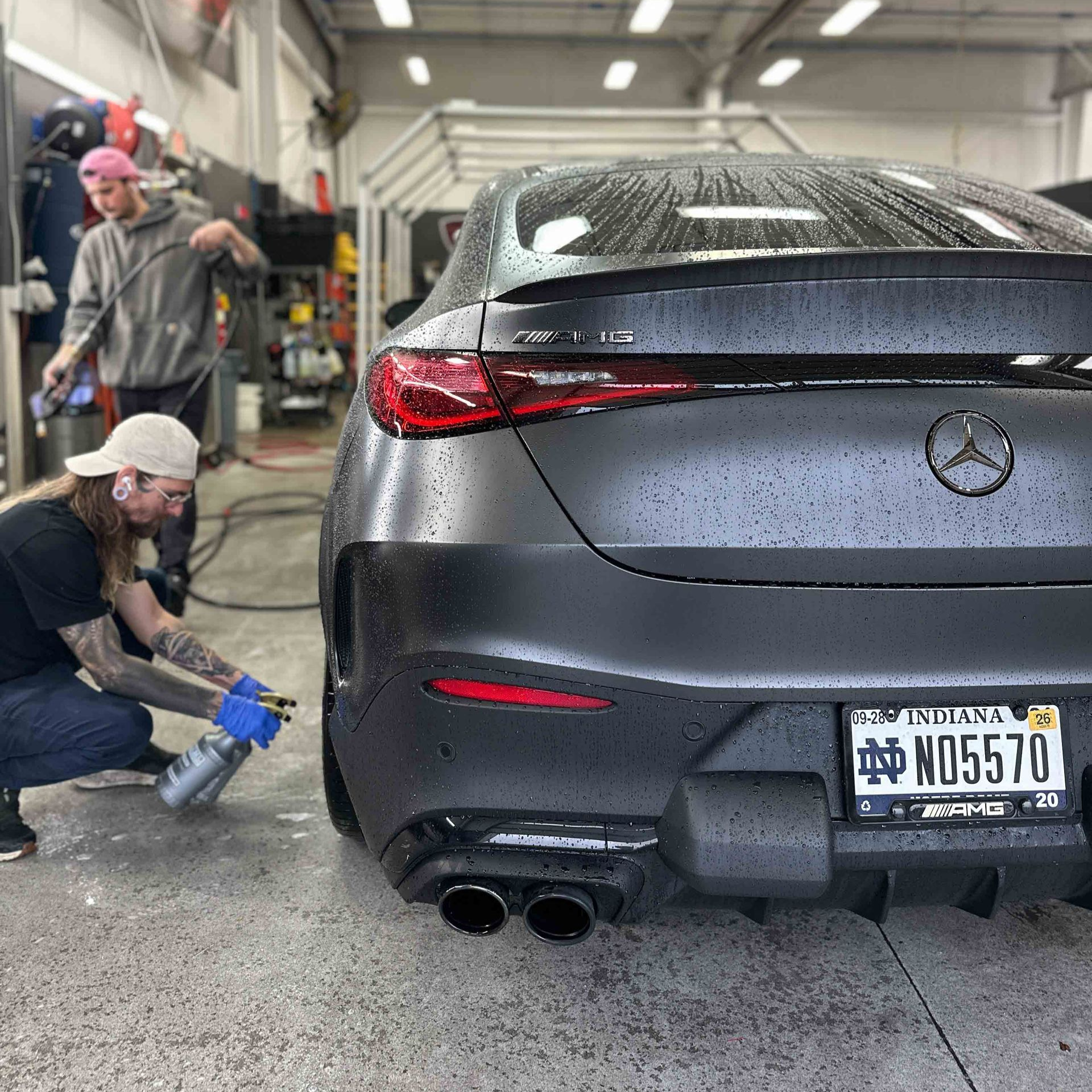 A man is holding a piece of glass with a picture of a cat on it