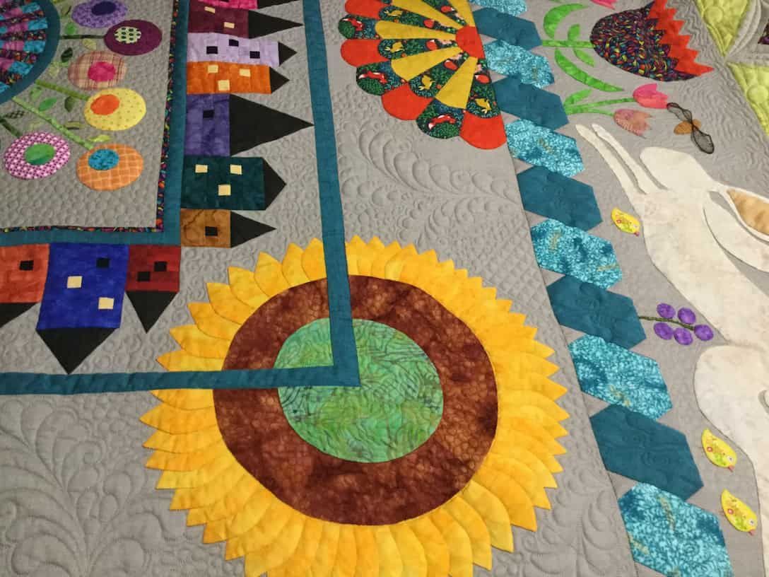 Colourful Quilt Featuring Floral and Geometric Designs on a Gray Background — Morning Star Quilting in Bateau Bay, NSW