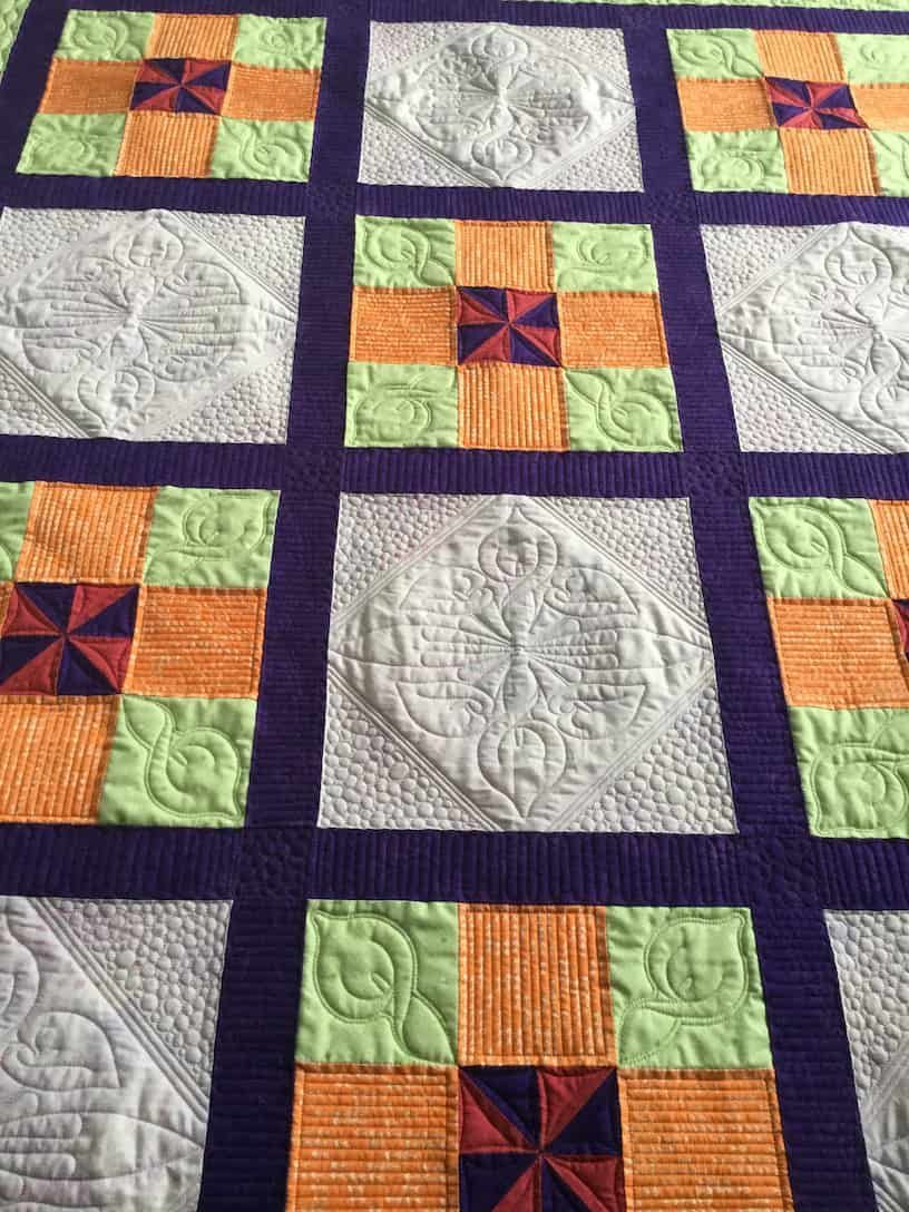 Quilt With Orange, Green, and Navy Blocks Separated by Purple Borders — Morning Star Quilting in Bateau Bay, NSW