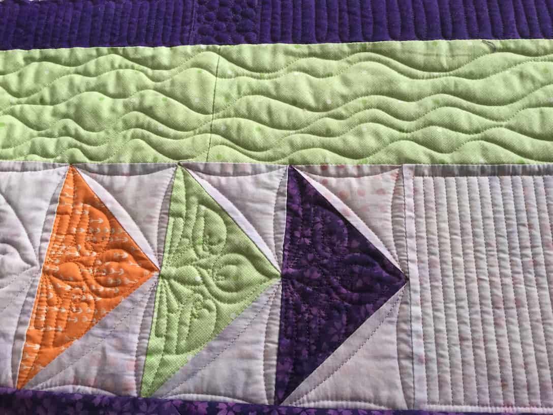 Quilted Fabric Detail With Geometric Shapes in Orange, Green, and Purple — Morning Star Quilting in Bateau Bay, NSW