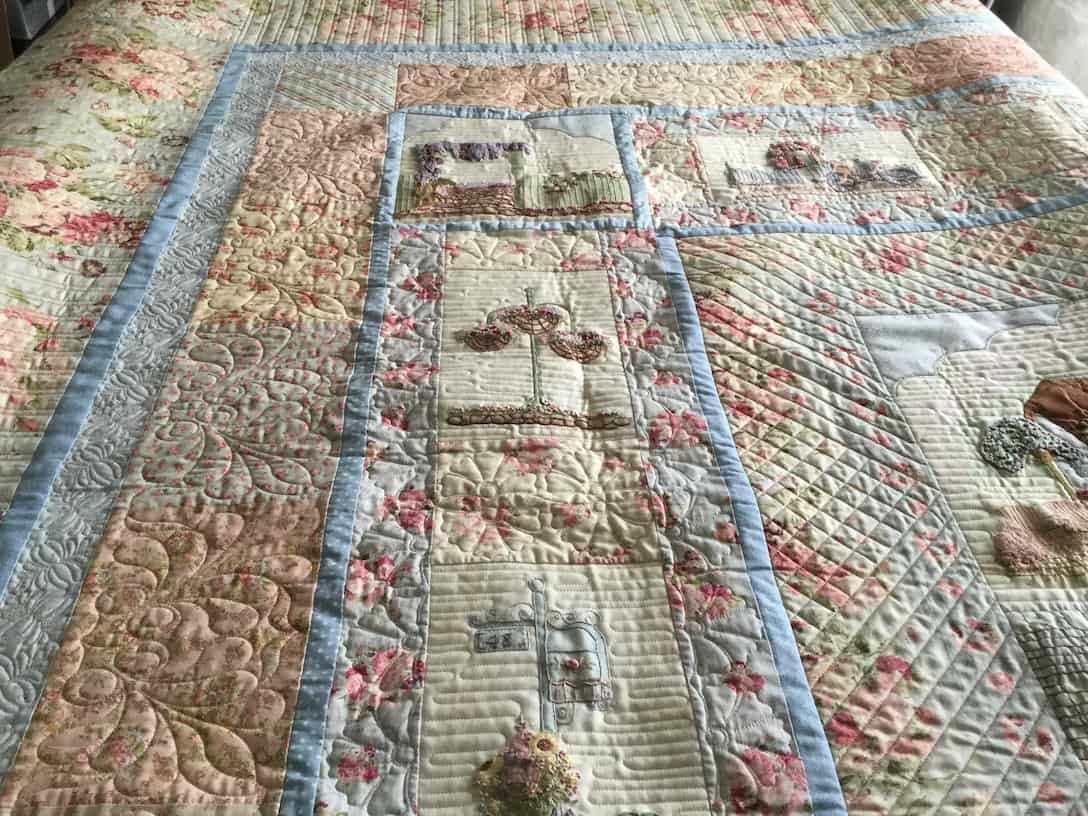 Quilted Bedspread With Floral and House Motifs in Pastel Colors — Morning Star Quilting in Bateau Bay, NSW