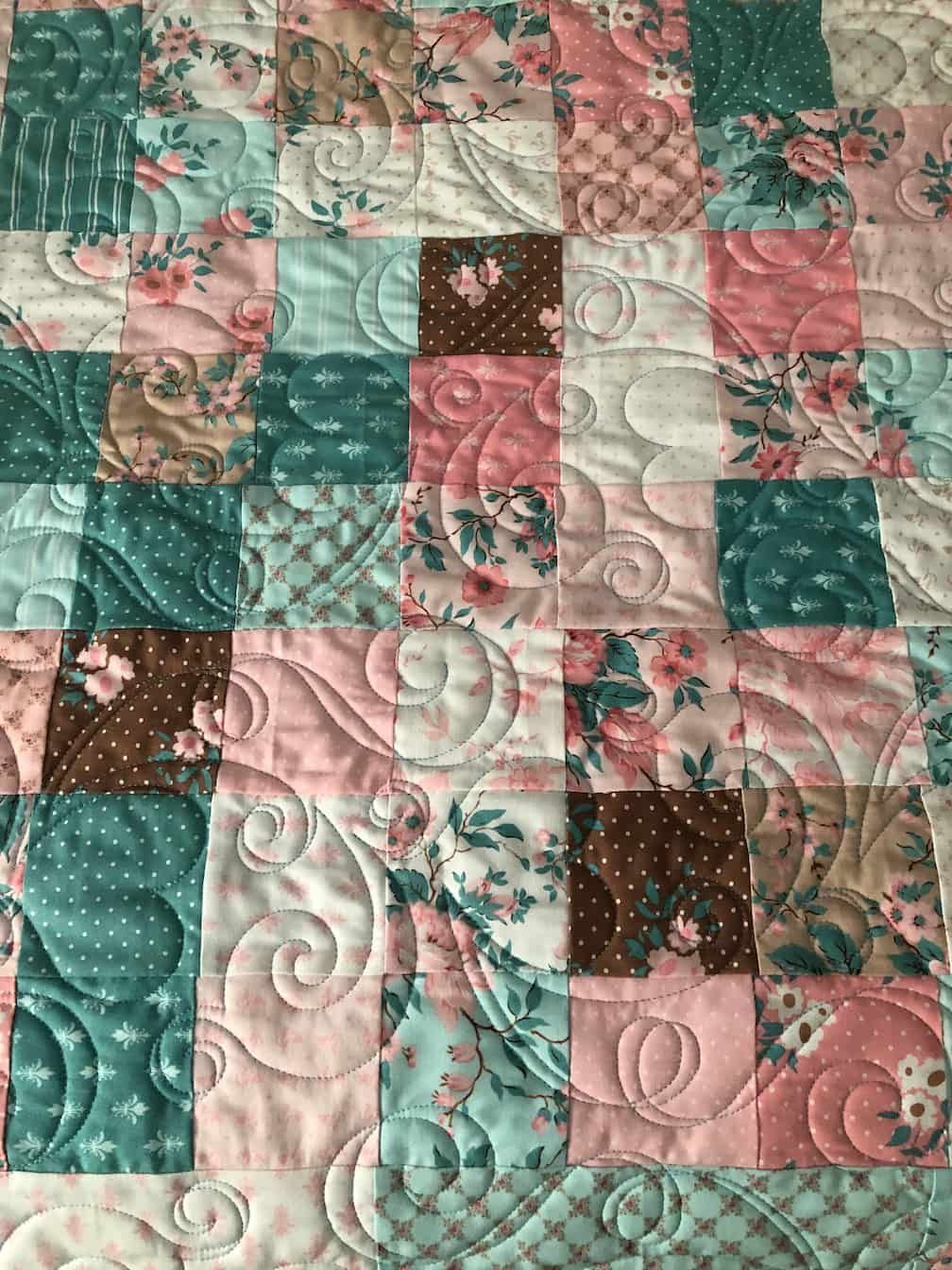 Quilted Fabric in Shades of Teal, Pink, and Brown With Floral Patterns — Morning Star Quilting in Bateau Bay, NSW