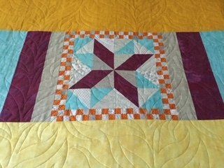 Quilt With Central Star Pattern in Burgundy and Turquoise — Morning Star Quilting in Bateau Bay, NSW