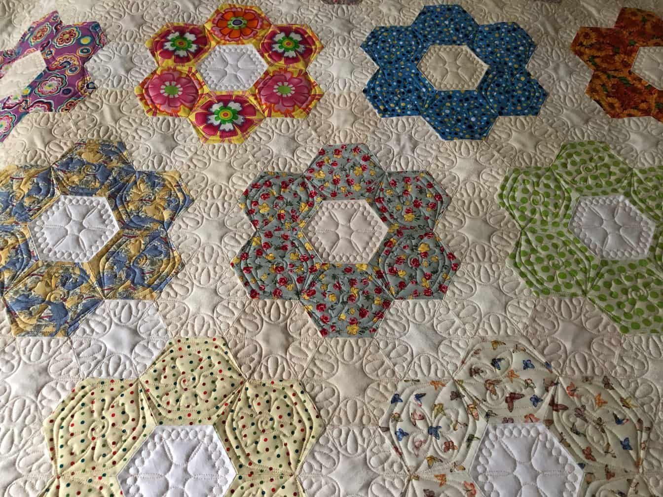 Close-up of a Quilt With Colourful Hexagonal Flower Patterns — Morning Star Quilting in Bateau Bay, NSW