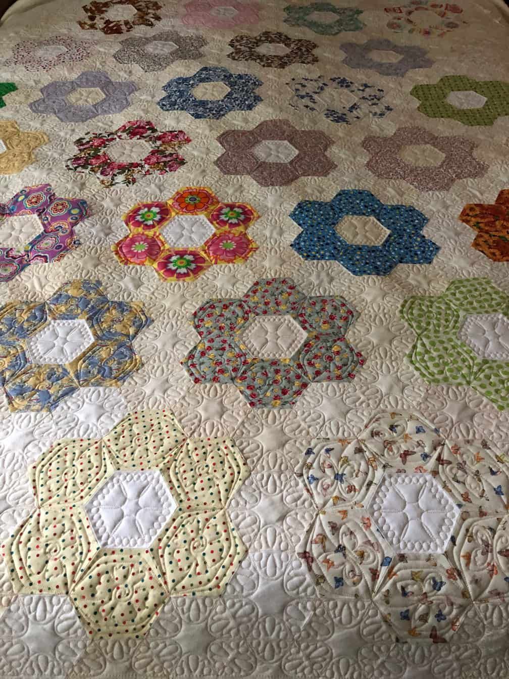 Quilt With Floral-shaped Patches in Various Colors — Morning Star Quilting in Bateau Bay, NSW