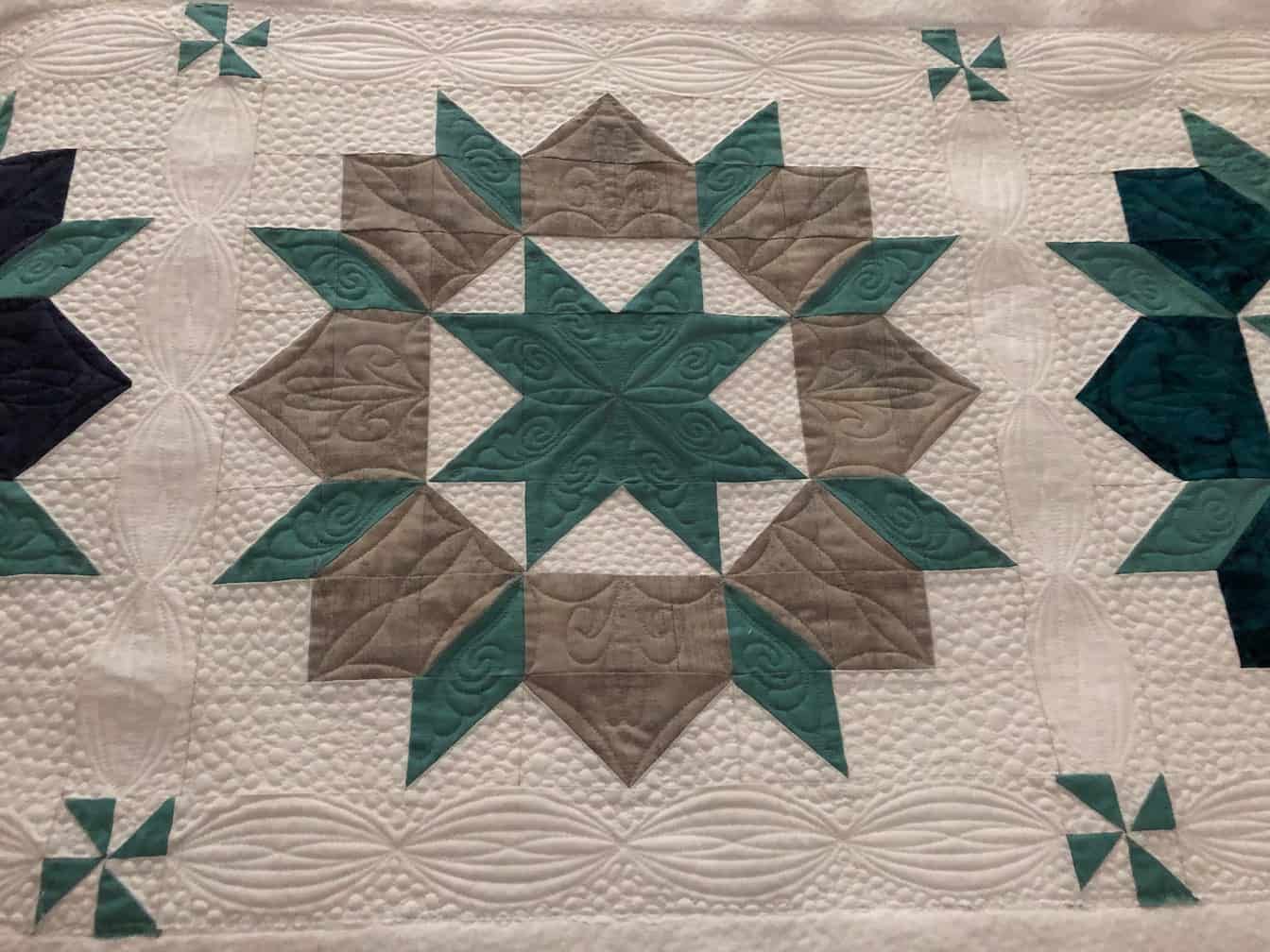 Quilted Textile With a Central Teal and Gray Star Pattern — Morning Star Quilting in Bateau Bay, NSW