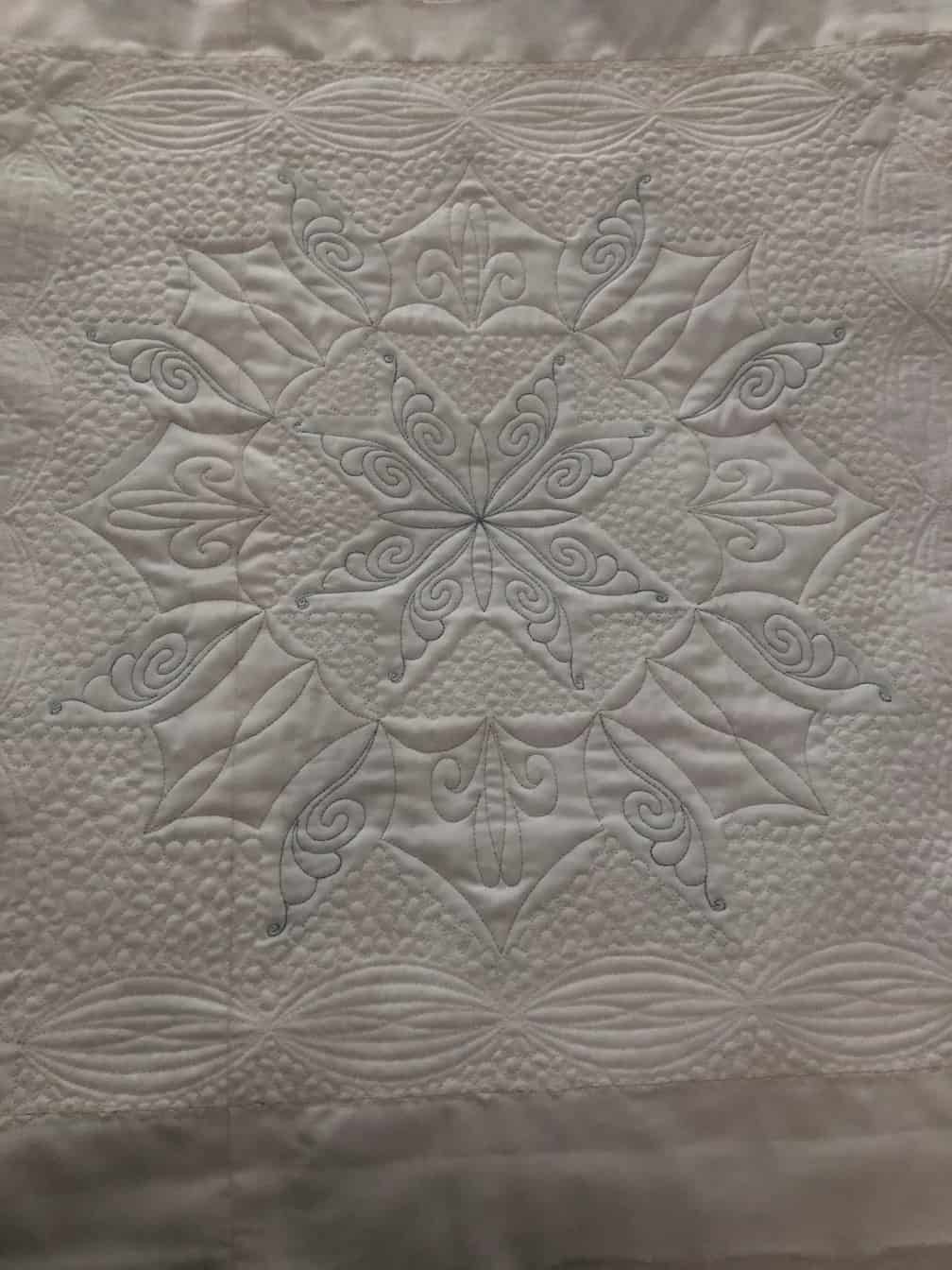 White Quilted Textile With Elaborate Embroidered Central Starburst Pattern — Morning Star Quilting in Bateau Bay, NSW