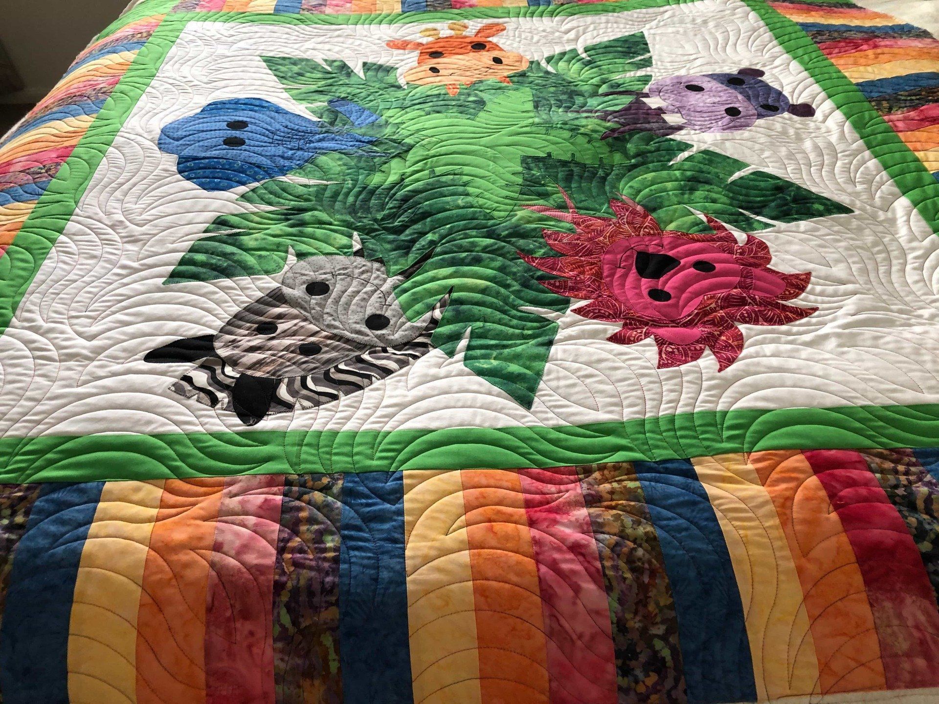 Colourful Quilt With Applique Animals and Tropical Plants — Morning Star Quilting in Bateau Bay, NSW