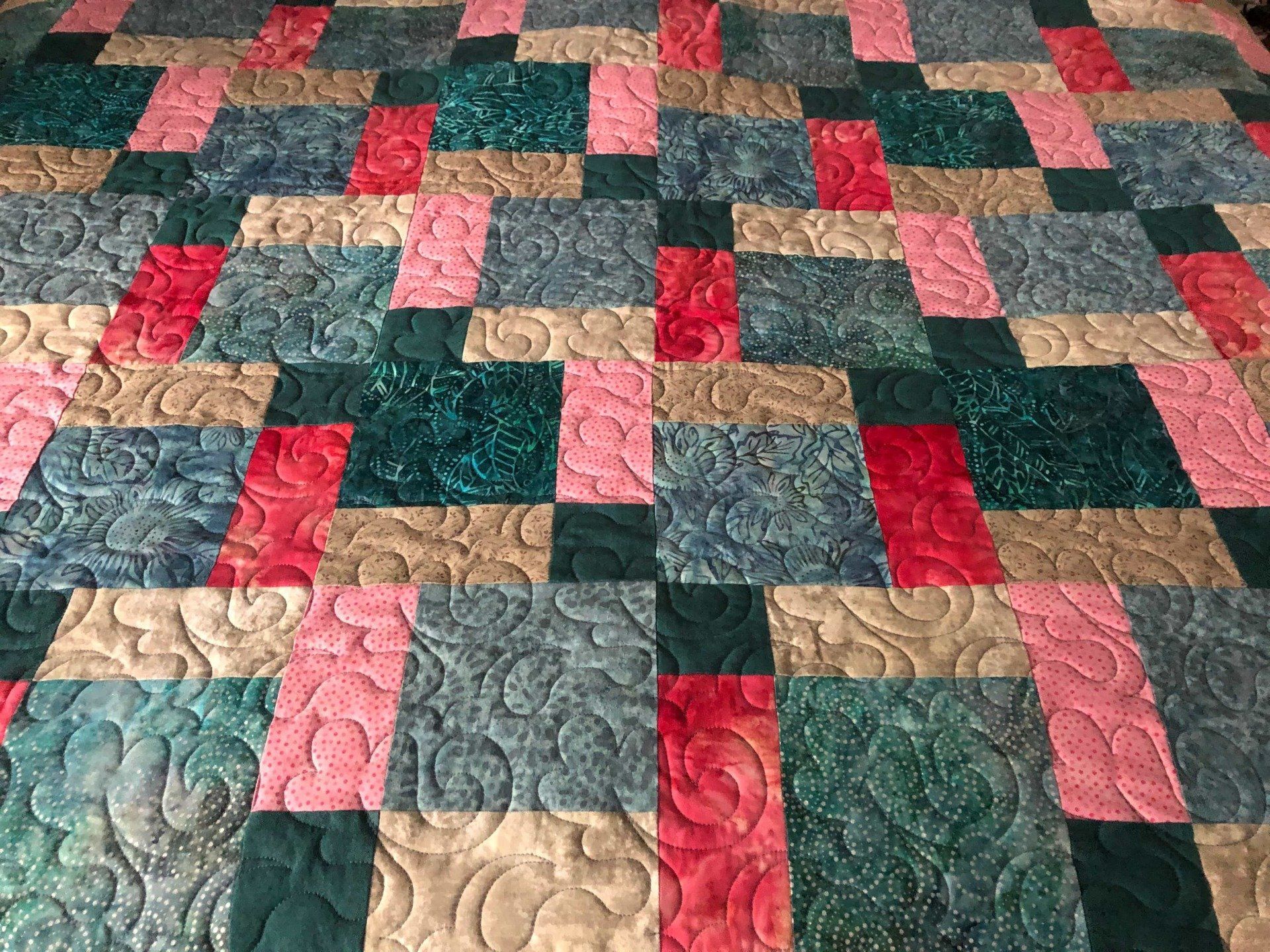 Quilt With a Block Pattern in Shades of Teal, Pink, Red, and Tan — Morning Star Quilting in Bateau Bay, NSW
