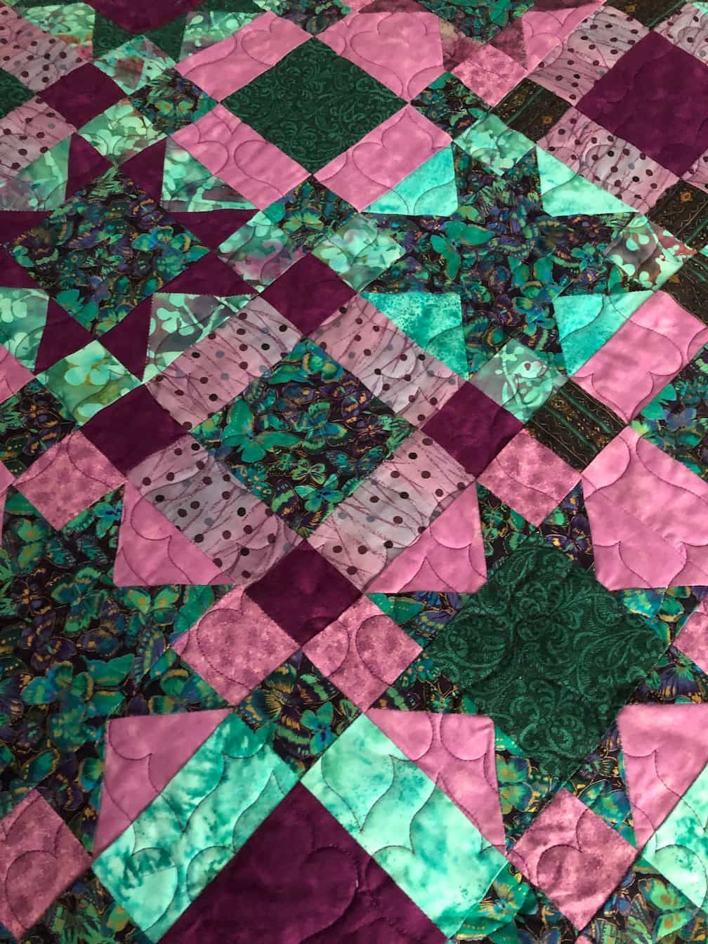 Close-up of a Colourful Quilt With Geometric Patterns in Purple, Teal, and Green — Morning Star Quilting in Bateau Bay, NSW