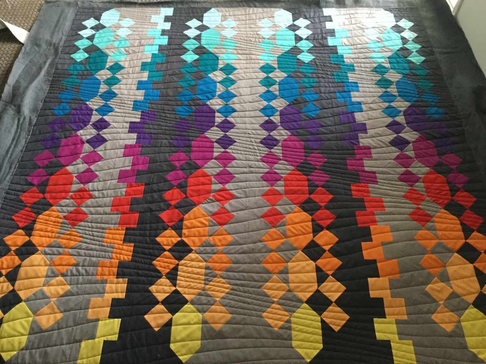 Quilt With Rows of Colourful Diamonds — Morning Star Quilting in Bateau Bay, NSW
