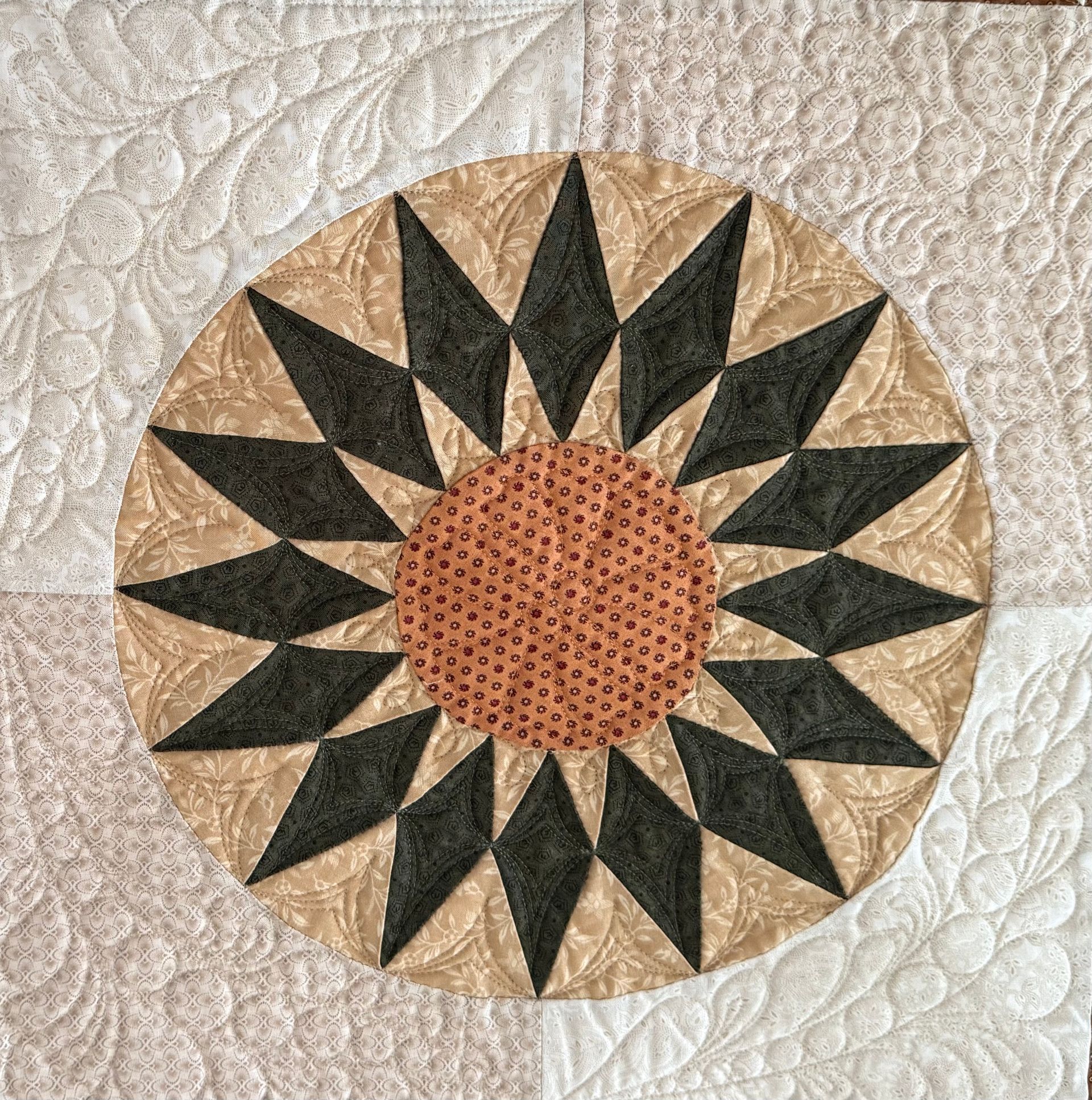 Quilted block with tan, black, and orange floral design on white background — Morning Star Quilting in Bateau Bay, NSW