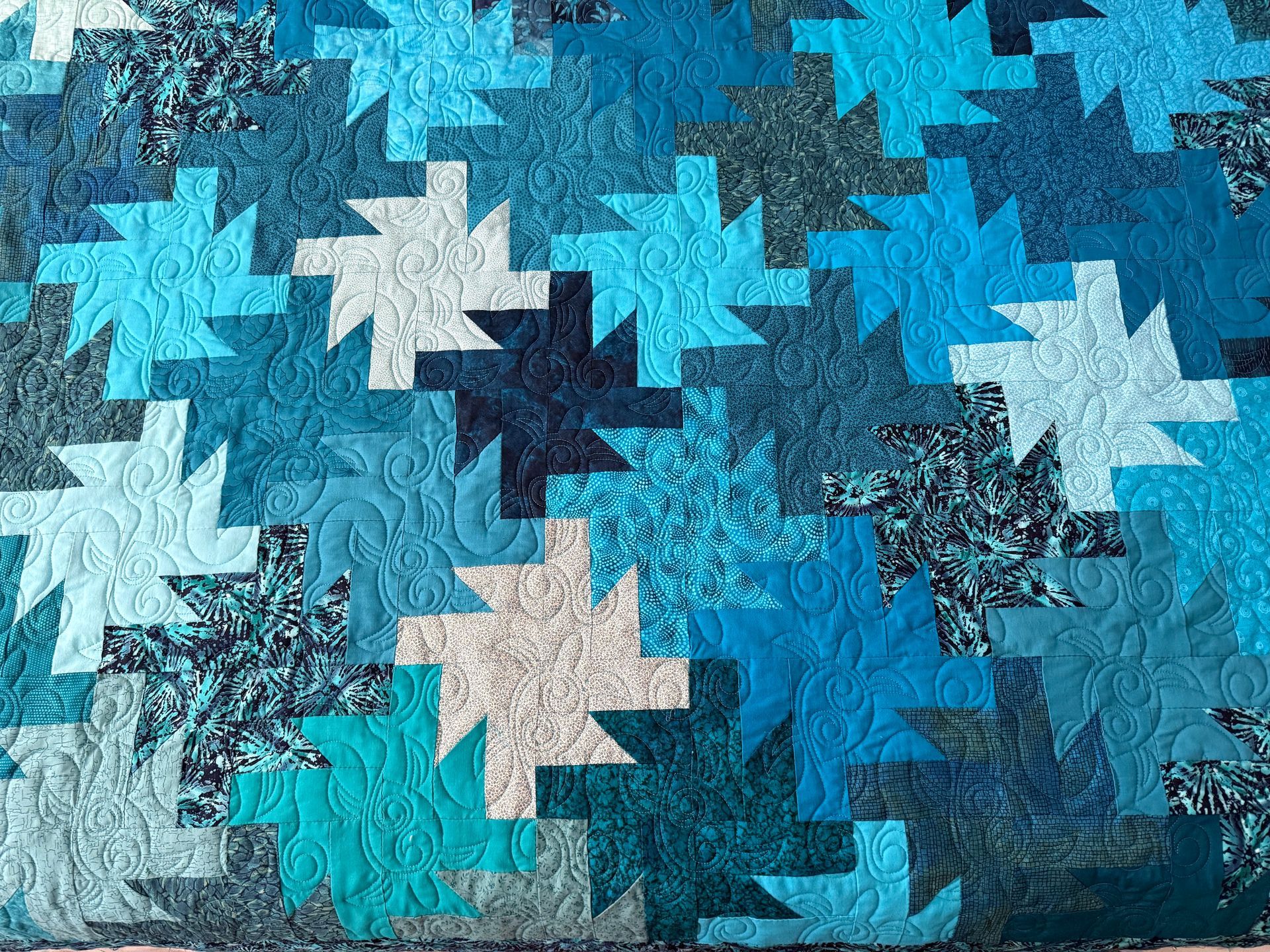 Blue quilt with a repeating starburst pattern — Morning Star Quilting in Bateau Bay, NSW