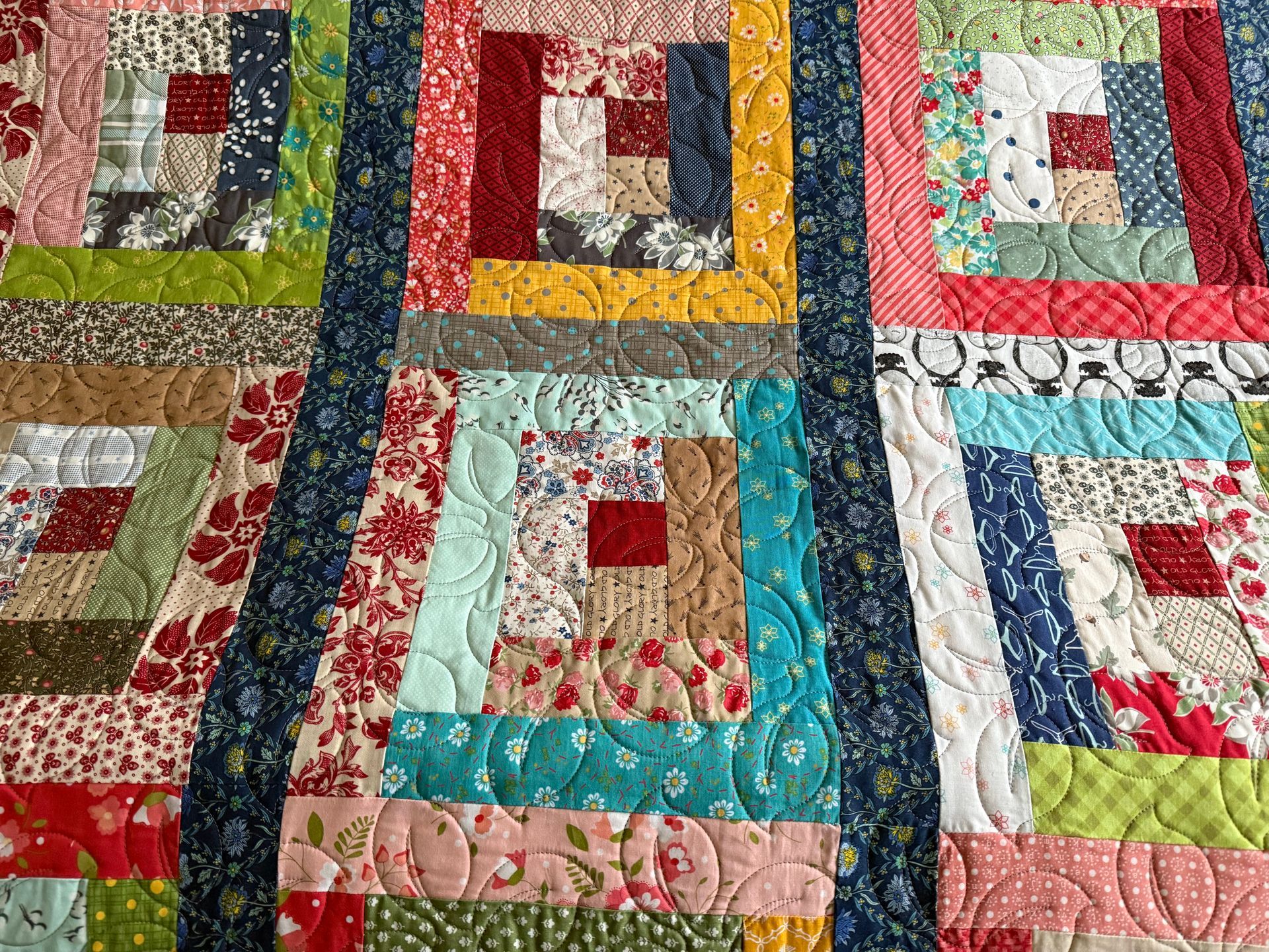 Colourful, quilted fabric with square log cabin blocks and linear quilting patterns — Morning Star Quilting in Bateau Bay, NSW