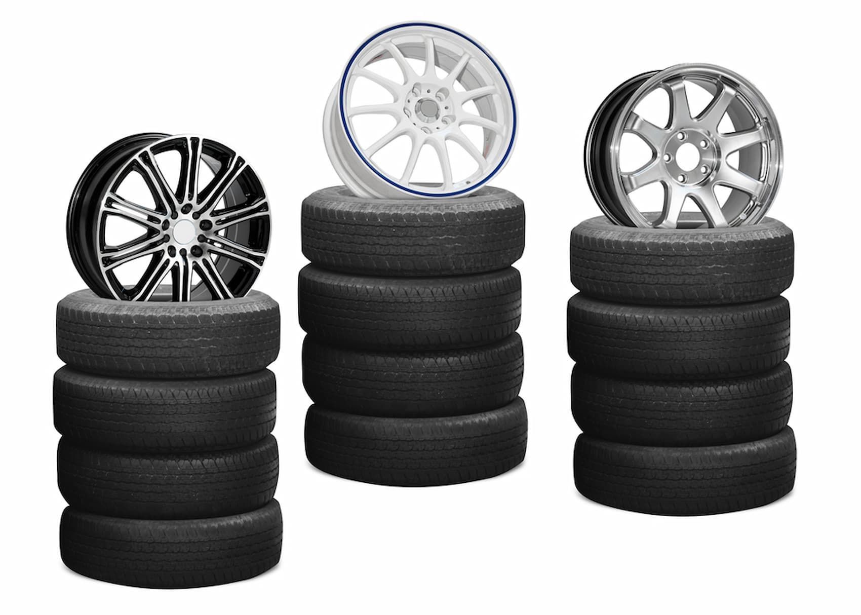 Three Stacks of Tires with Wheels on Top of Them — Chinderah Smash Repairs in Chinderah, NSW