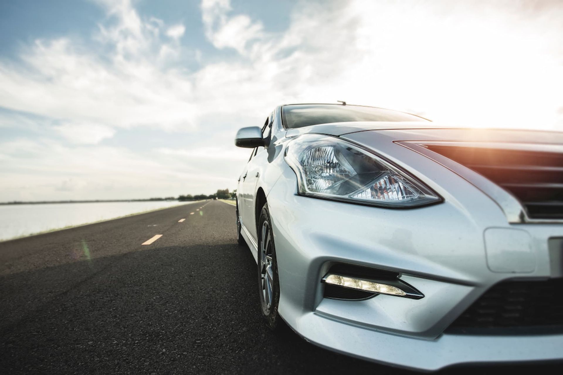 A Silver Car Is Parked On The Side of A Road — Chinderah Smash Repairs in Chinderah, NSW