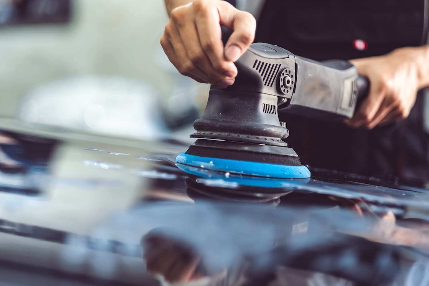A Person Is Polishing a Car with A Machine — Chinderah Smash Repairs in Chinderah, NSW