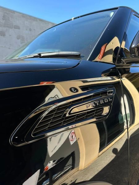 A Black Patrol Car Is Parked In Front Of A Building — Chinderah Smash Repairs in Chinderah, NSW