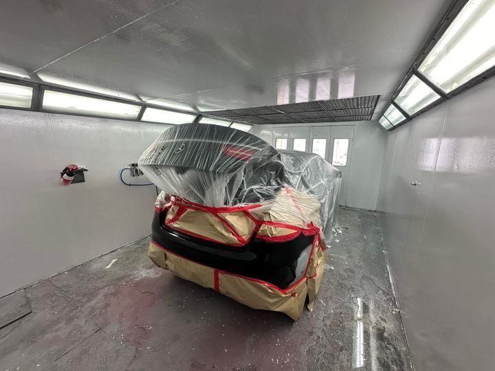 A Car Is Being Painted In A Paint Booth — Chinderah Smash Repairs in Chinderah, NSW